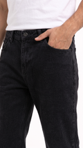 Close-up of a person wearing black denim jeans with a white tank top, showing the front pocket and side pocket with one hand in the pocket, from Meleche Fashion USA or Meléche (short as (Mé))