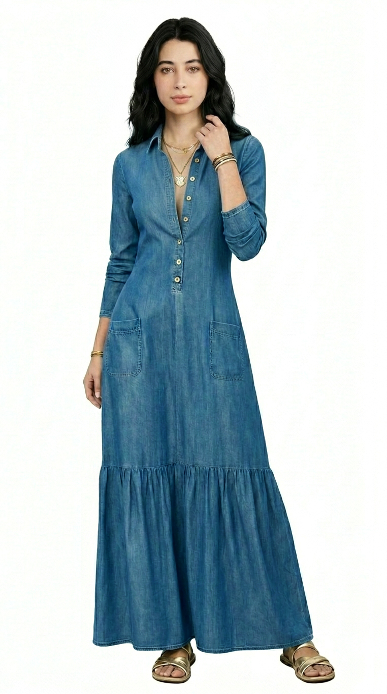 Woman wearing a long blue denim dress on a white background