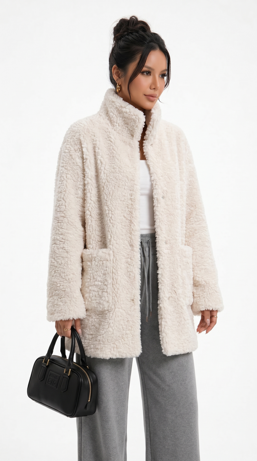 Woman wearing a cream sherpa coat with gray pants and a black handbag on a white background from Meleche Fashion USA or Meléche (short as (Mé))