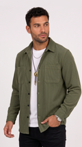 A man wearing an olive green long-sleeve button-up shirt over a white t-shirt and black pants, standing against a plain white studio background, from Meleche Fashion USA or Meléche (short as (Mé))