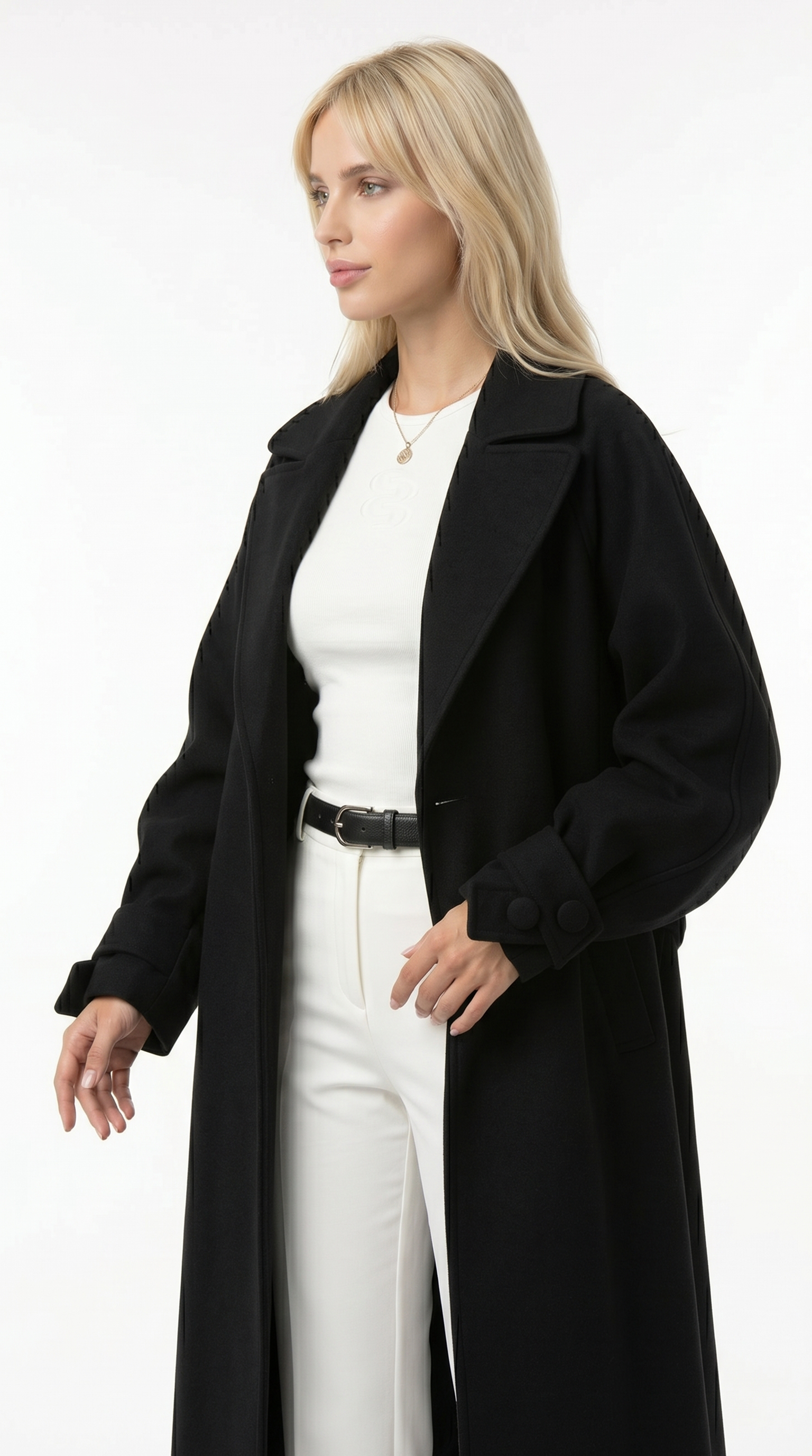 Woman wearing a black coat over a white outfit on a white background from Meleche or Meléche USA (short as (Mé))