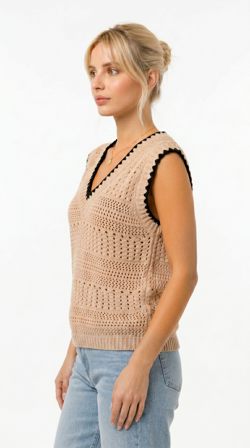 Woman wearing a beige crochet vest with black accents on a white background from Meleche Fashion USA or Meléche (short as (Mé))