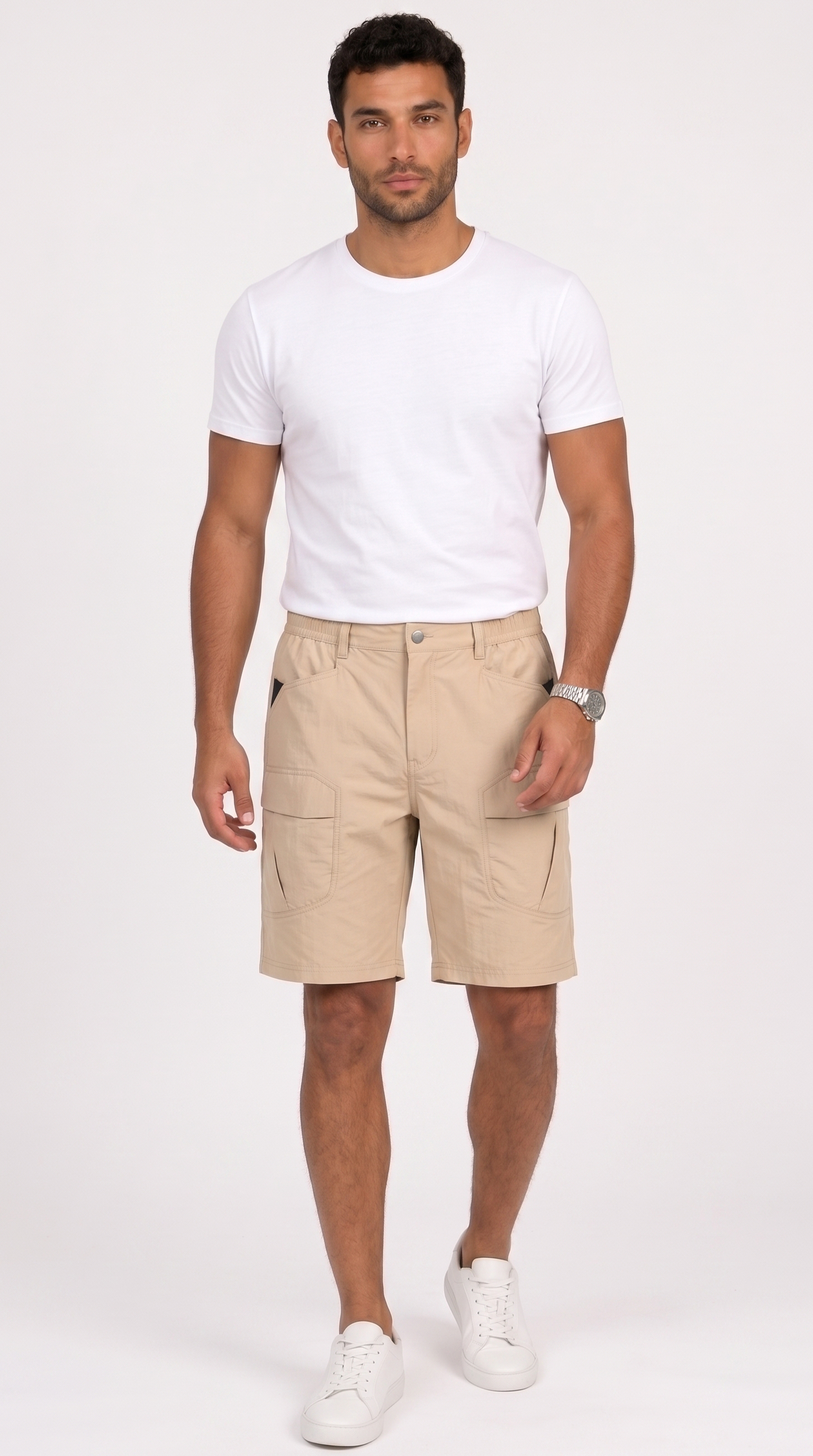 A man modeling a pair of beige cargo shorts, paired with a white t-shirt and white sneakers, standing against a plain white studio background, from Meleche Fashion USA or Meléche (short as (Mé))