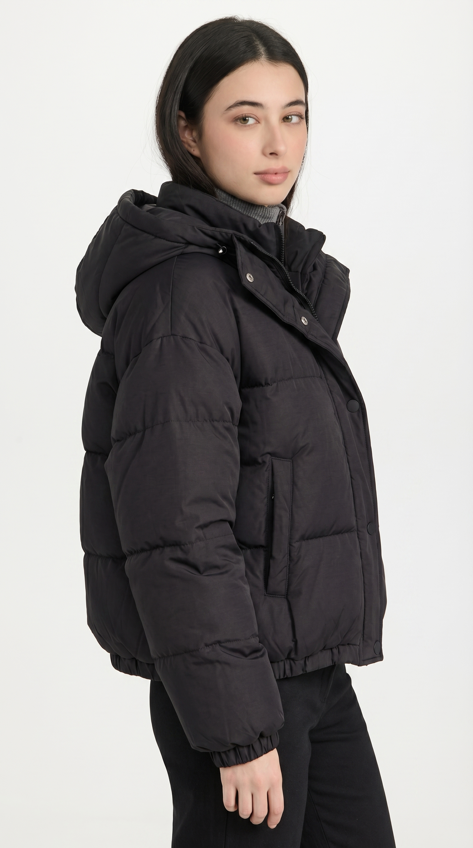 Person wearing a black puffer jacket on a white background from Meleche USA or Meléche (short as (Mé))