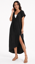 Woman wearing a black dress with a white top on a white background