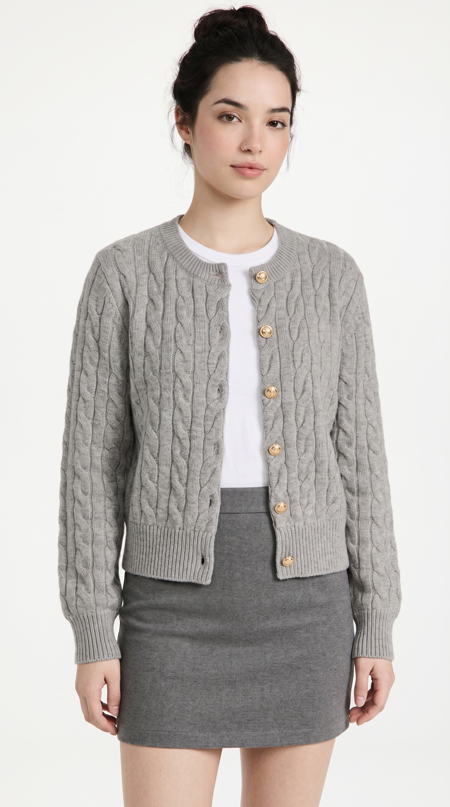 Woman wearing a gray cable knit cardigan with gold buttons on a white background from Meleche or Meléche (short as (Mé))