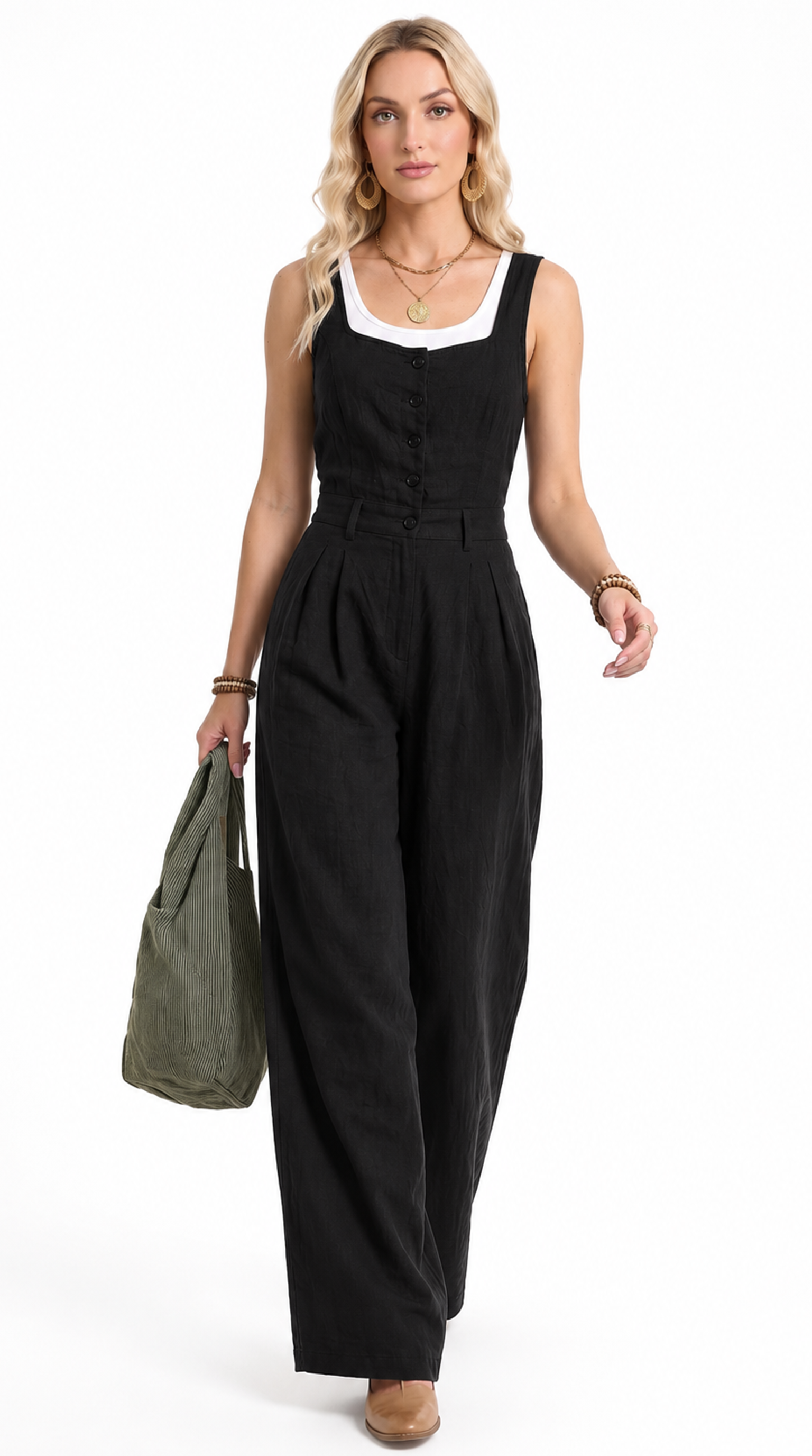 A woman modeling a black sleeveless wide-leg jumpsuit with a white scoop neck trim, holding an olive green tote bag against a plain white background.