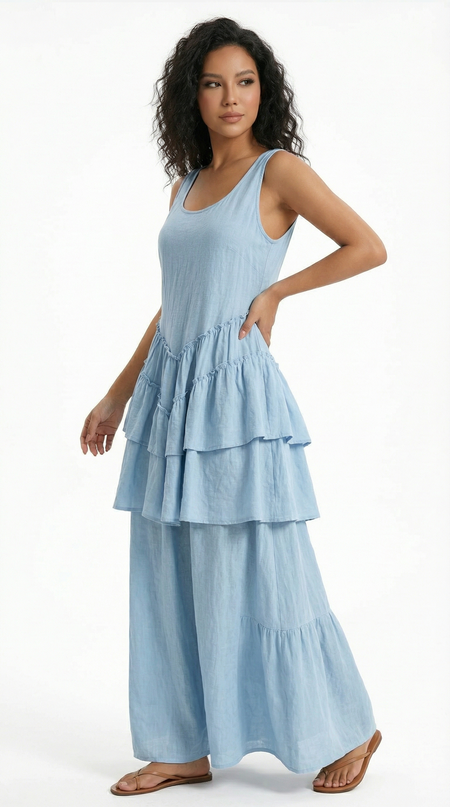 Woman wearing a light blue tiered dress on a white background