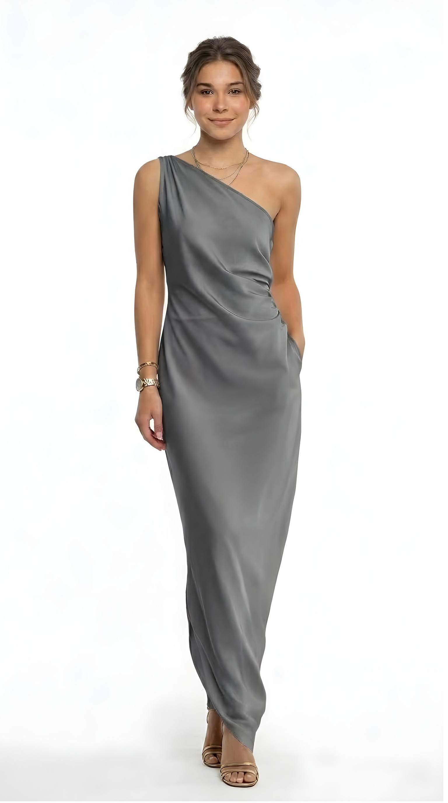 Woman wearing a green sheer dress holding a beige bag on a white background