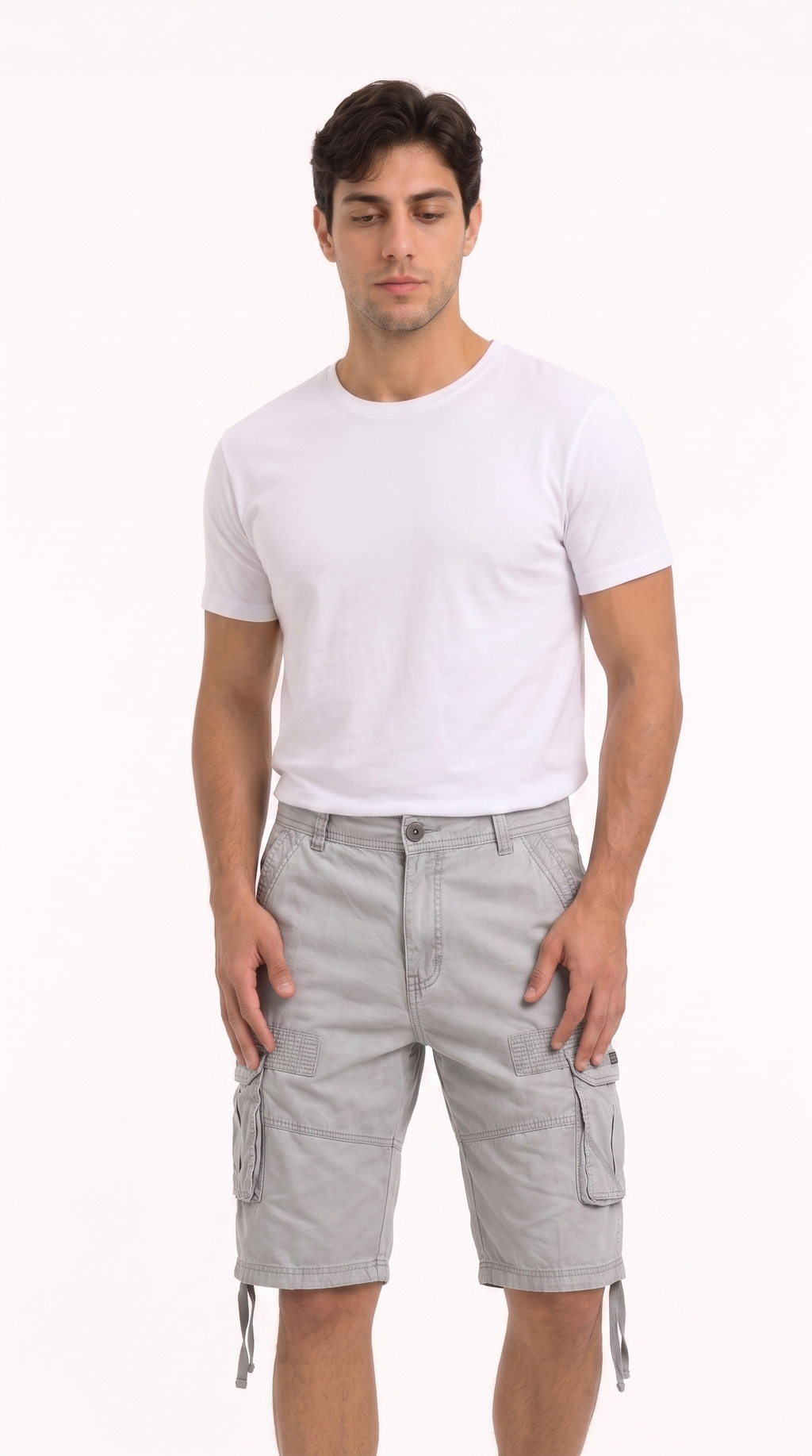 A man modeling a plain white short-sleeve crewneck t-shirt and light gray cargo shorts against a solid white studio background, from Meleche Fashion USA or Meléche (short as (Mé))