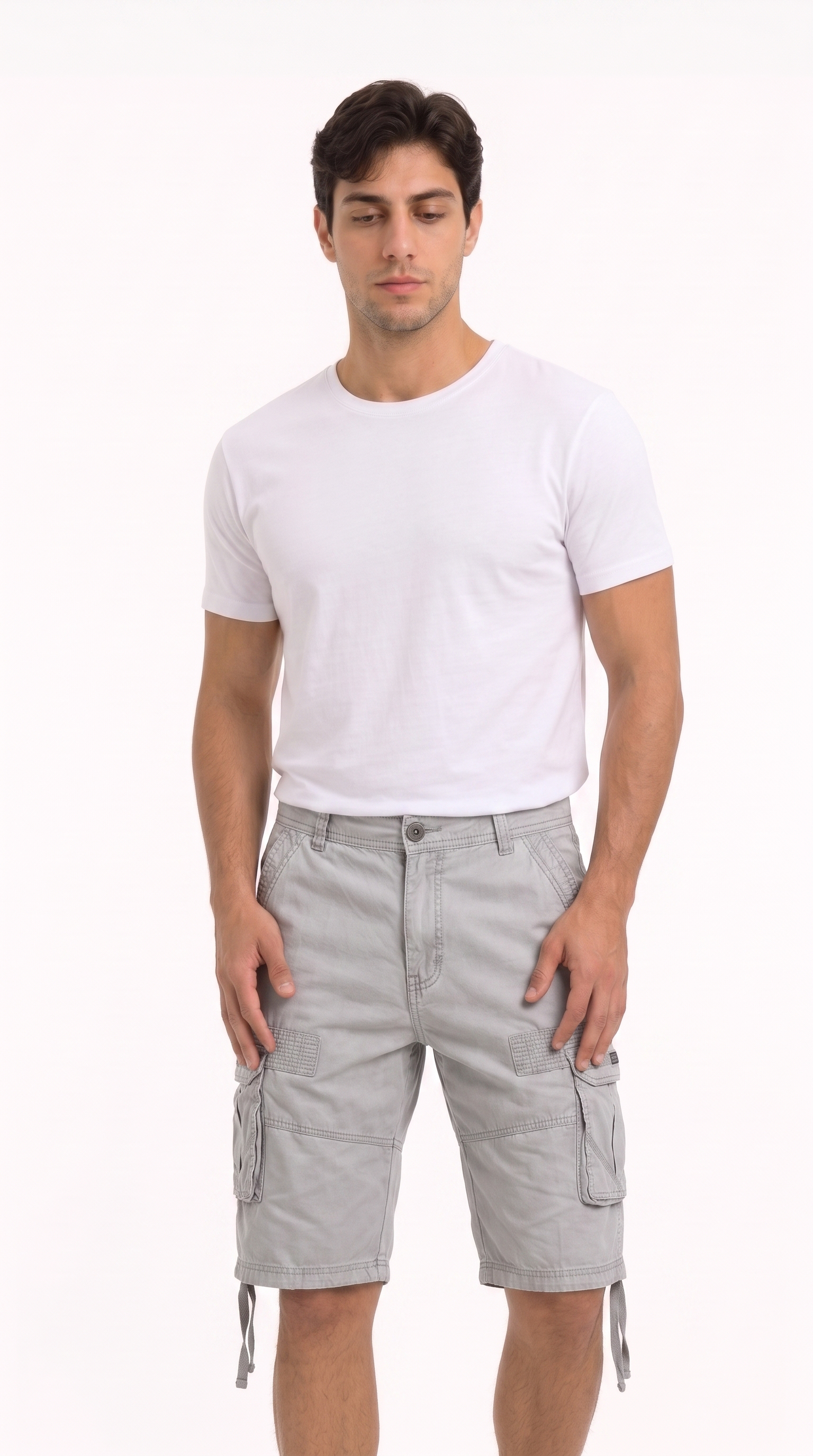 A man modeling a plain white short-sleeve crewneck t-shirt and light gray cargo shorts against a solid white studio background, from Meleche Fashion USA or Meléche (short as (Mé))