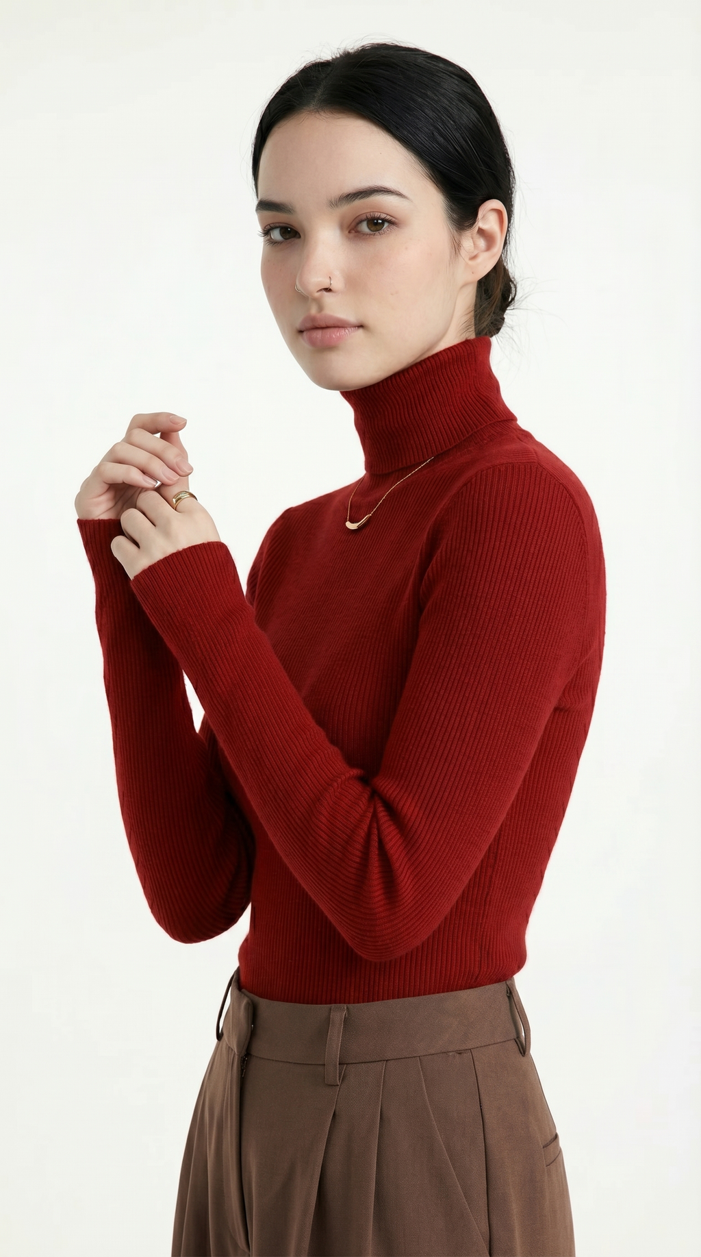 Woman wearing a red turtleneck sweater and brown pants on a white background from Meleche USA or Meléche (short as (Mé))