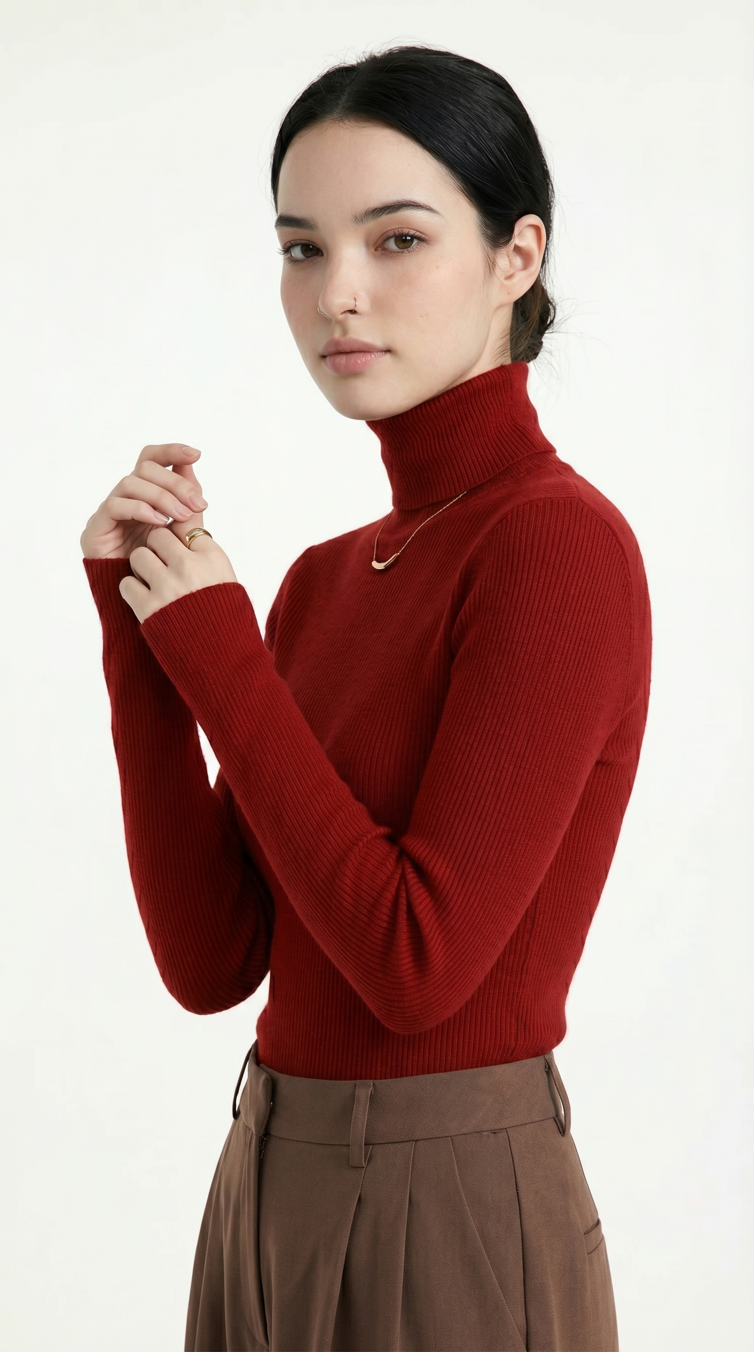 Woman wearing a red turtleneck sweater and brown pants on a white background from Meleche USA or Meléche (short as (Mé))