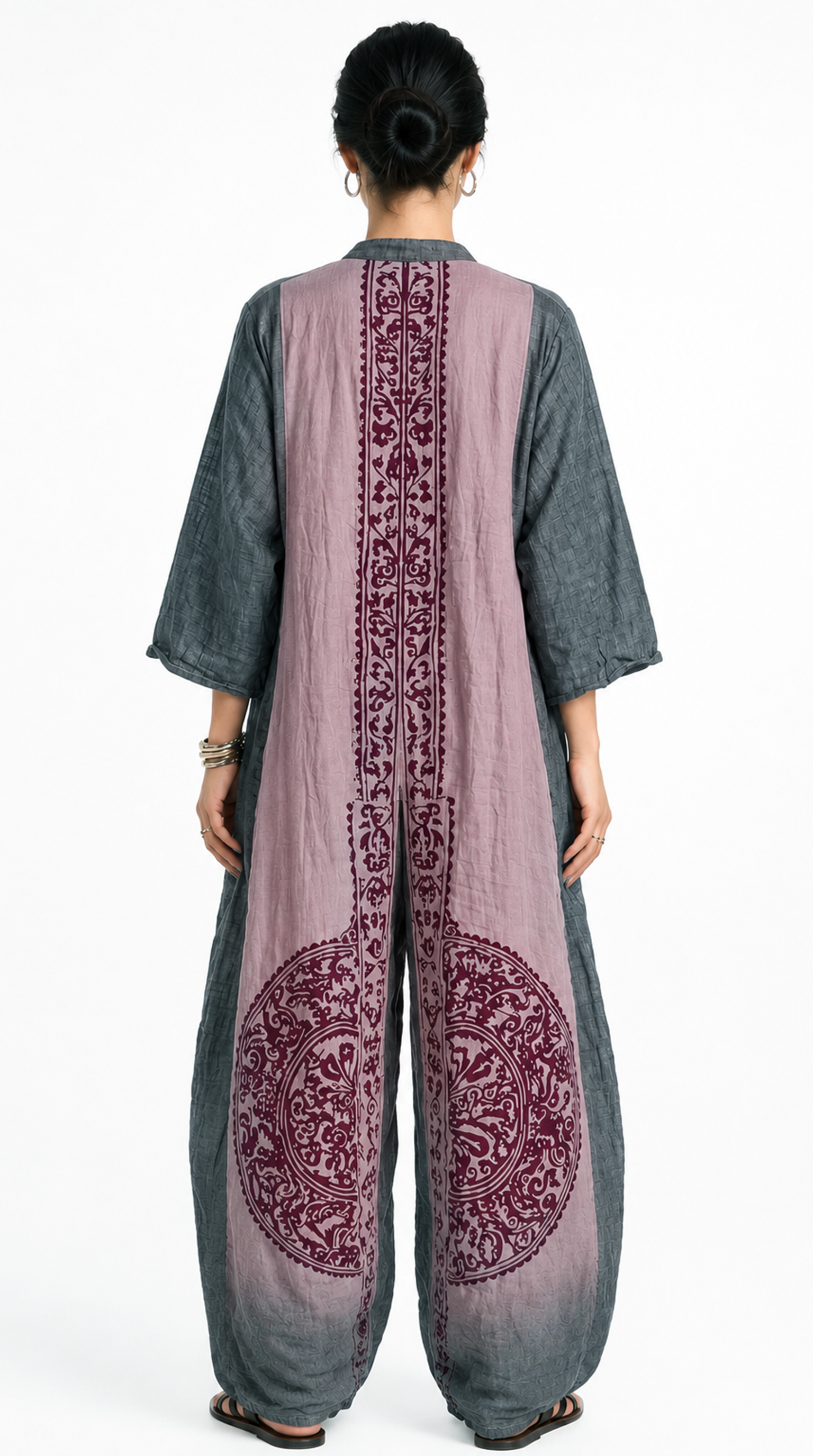 Person wearing a long, light purple dress with intricate patterns on the back and gray sleeves and pants, from Meleche Fashion USA or Meléche (short as (Mé))