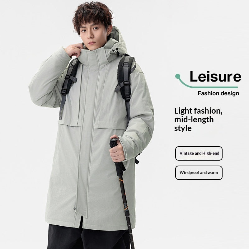 Person wearing a light gray winter coat from Meleche or Meléche (short as (Mé)) with a backpack and hiking poles on a white background