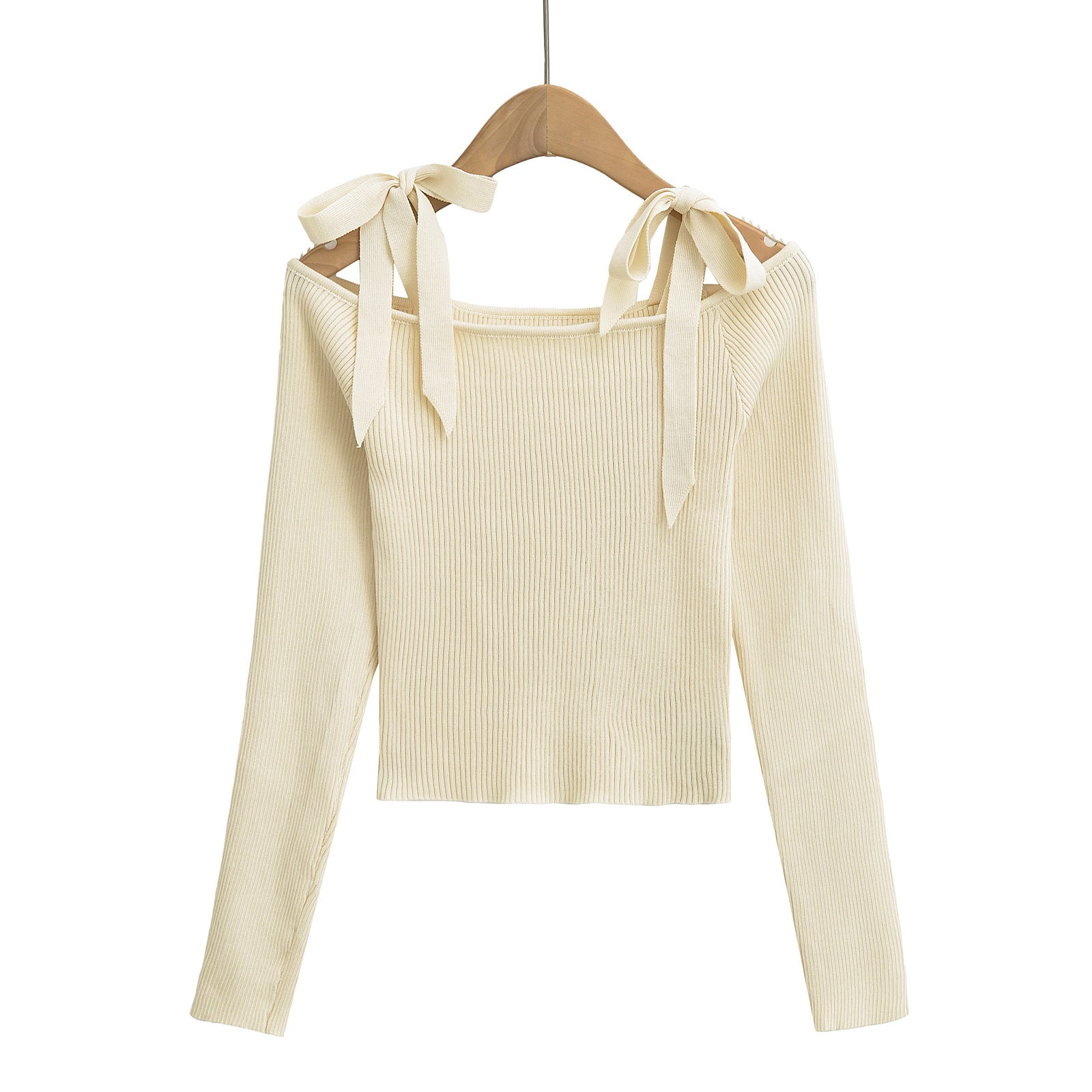 Beige ribbed sweater with bow details on a hanger from Meleche or Meléche (short as (Mé))