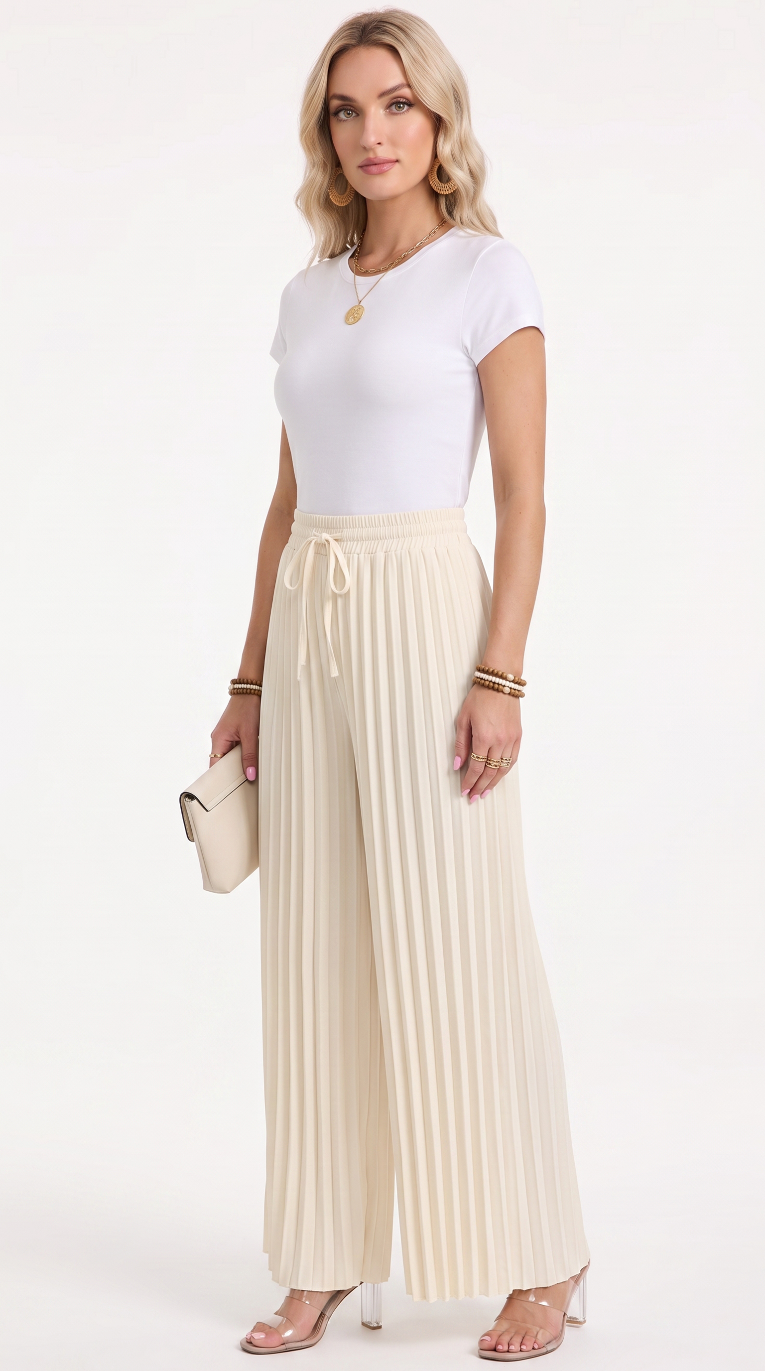 A woman modeling a white short-sleeve top and cream pleated wide-leg pants with a drawstring waist, standing against a plain white studio background and holding a small cream clutch, from Meleche Fashion USA or Meléche (short as (Mé))
