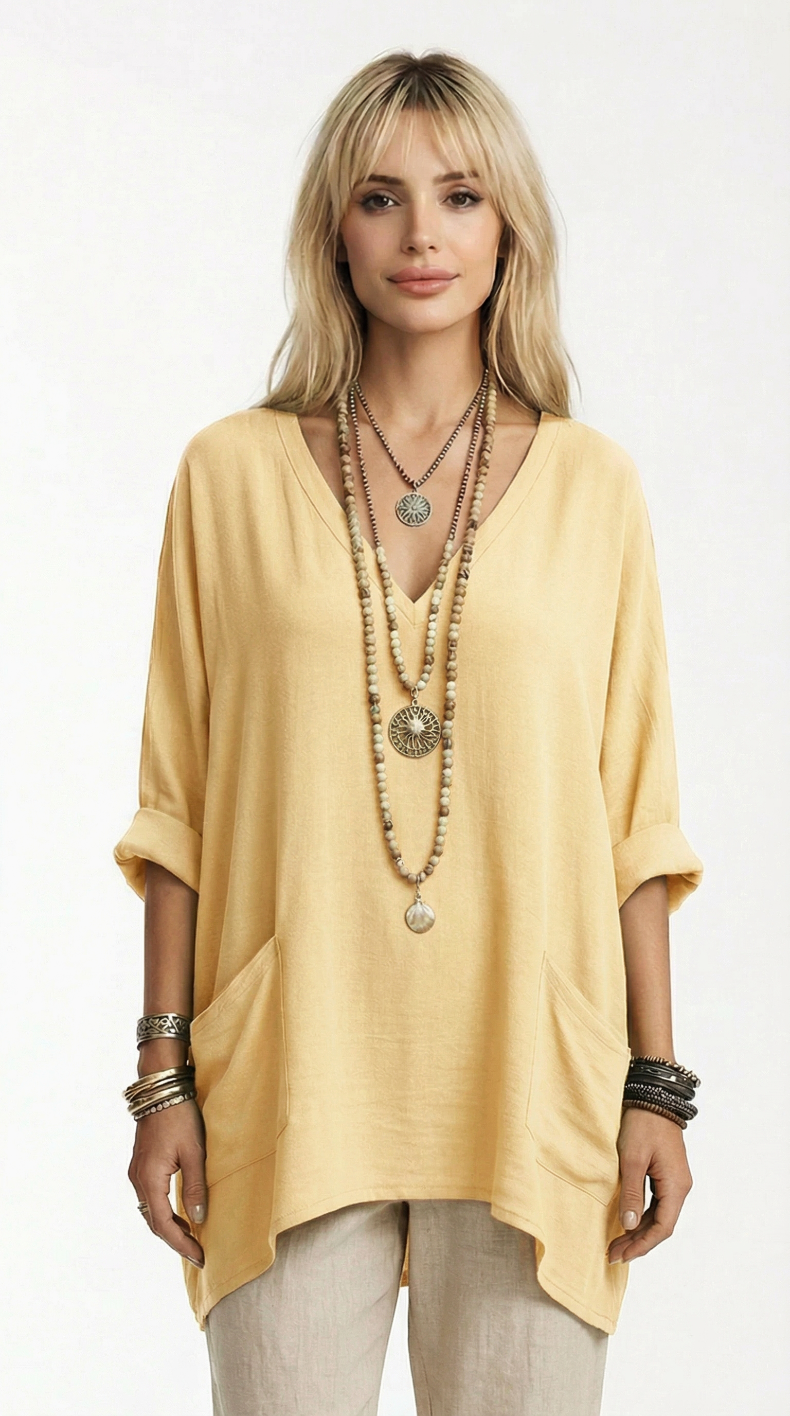 Woman wearing a floral blouse with a cream jacket and blue jeans on a white background from Meleche or Meléche (short as (Mé))