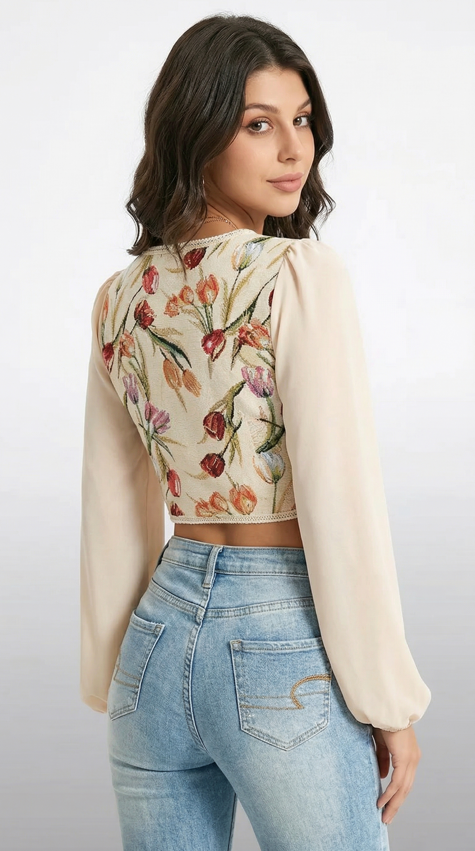Woman wearing a floral blouse with a cream jacket and blue jeans on a white background from Meleche or Meléche (short as (Mé))