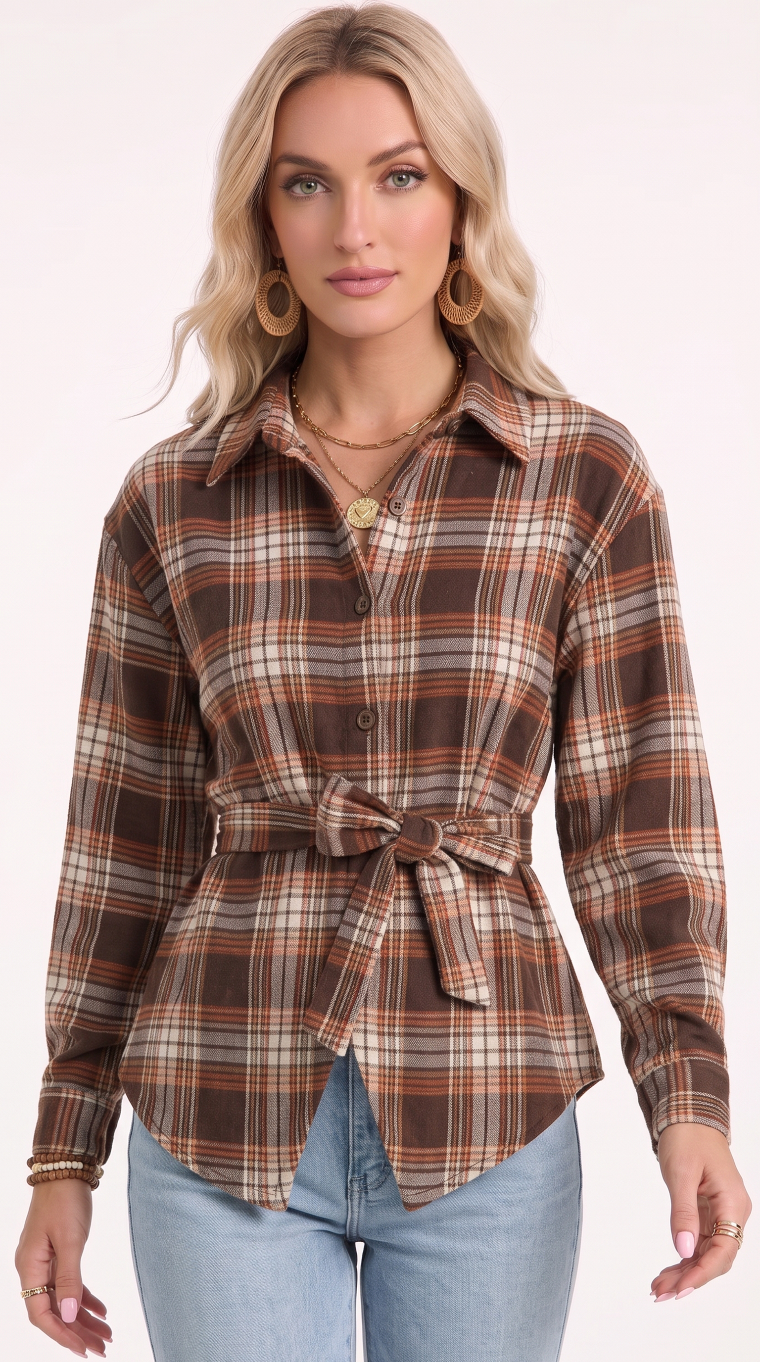 A woman modeling a brown, beige, and orange plaid long-sleeve button-up shirt with a matching tie belt, paired with light blue jeans against a plain white studio background, from Meleche Fashion USA or Meléche (short as (Mé))