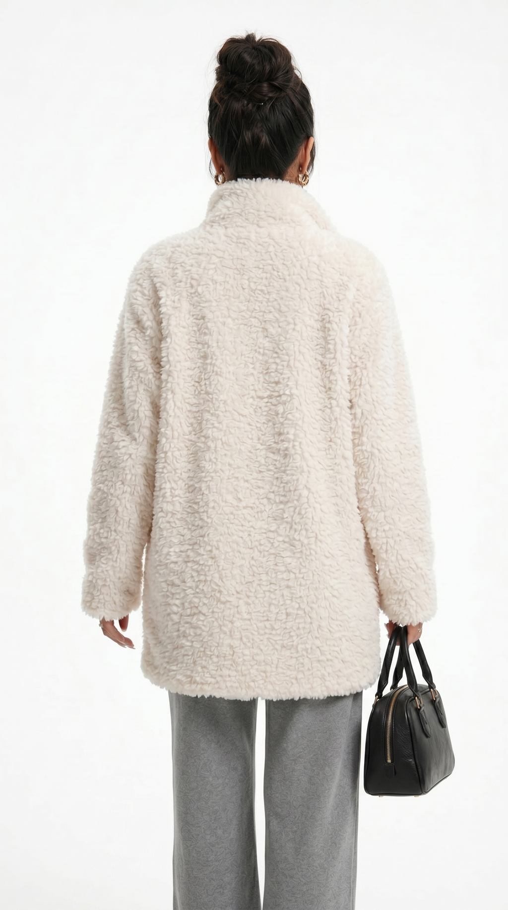 Person wearing a beige cardigan and holding a black handbag on a white background from Meleche Fashion USA or Meléche (short as (Mé))