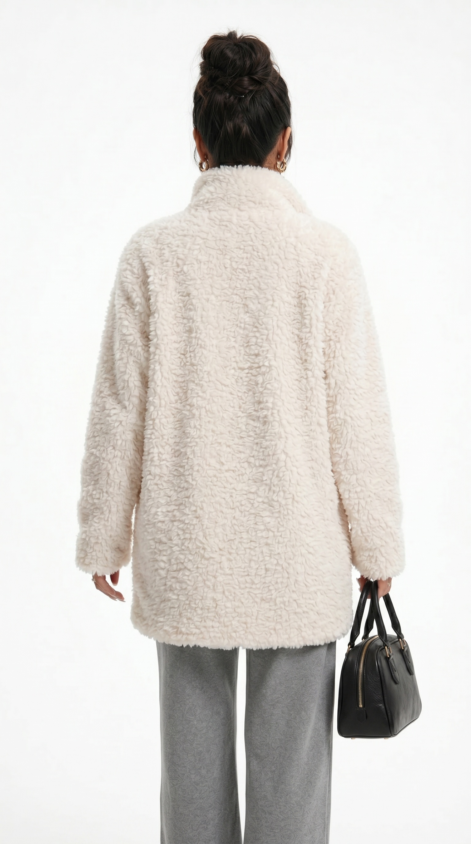 Person wearing a beige cardigan and holding a black handbag on a white background from Meleche Fashion USA or Meléche (short as (Mé))