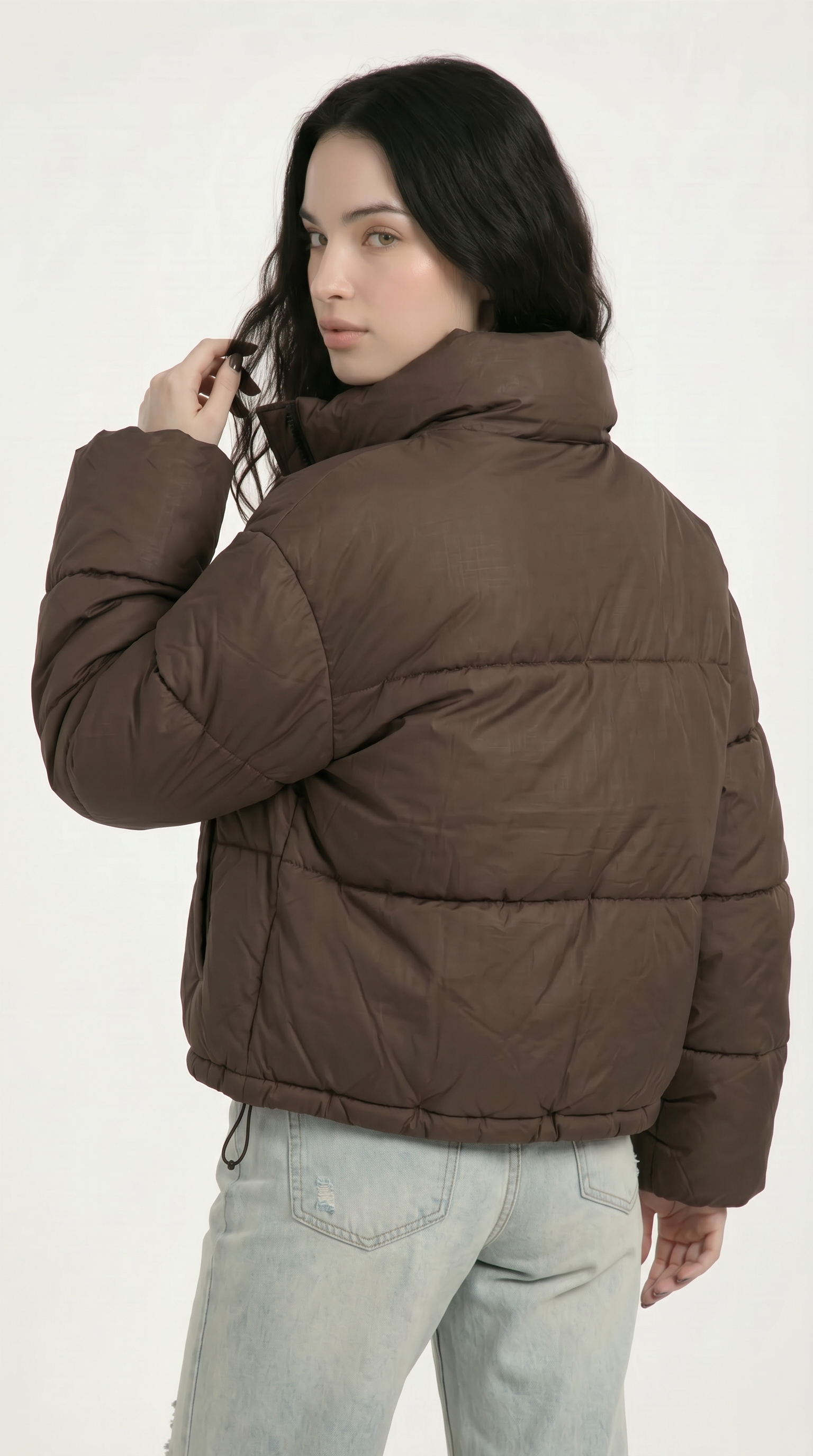Woman wearing a brown puffer jacket on a white background from Meleche USA or Meléche (short as (Mé))