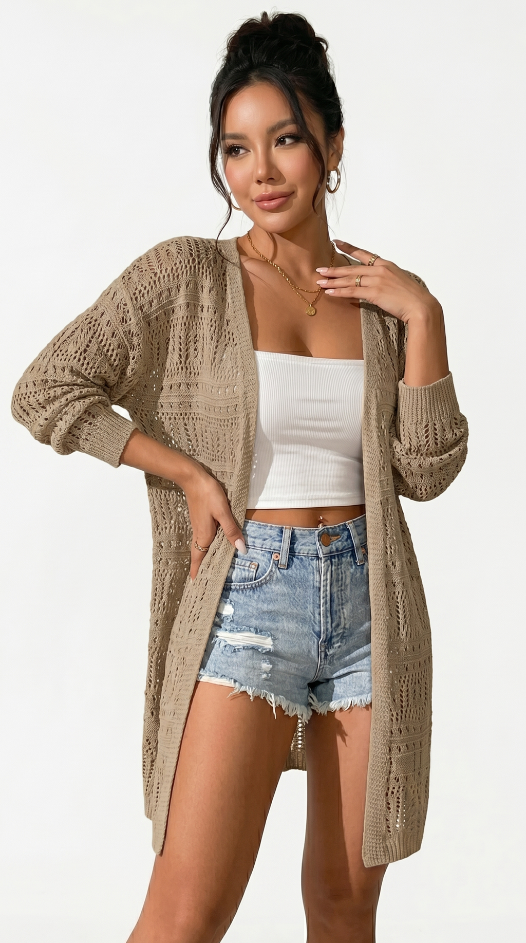 Woman wearing a beige cardigan, white top, and denim shorts on a white background from Meleche or Meléche (short as (Mé))
