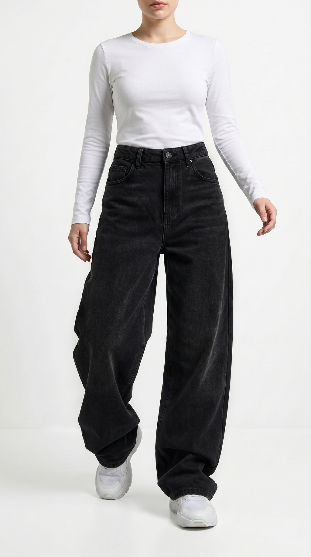 Person wearing black wide-leg jeans and a white long-sleeve top on a white background, Relaxed Fit Egyptian cotton jeans from Meleche Fashion USA or Meléche (short as (Mé))