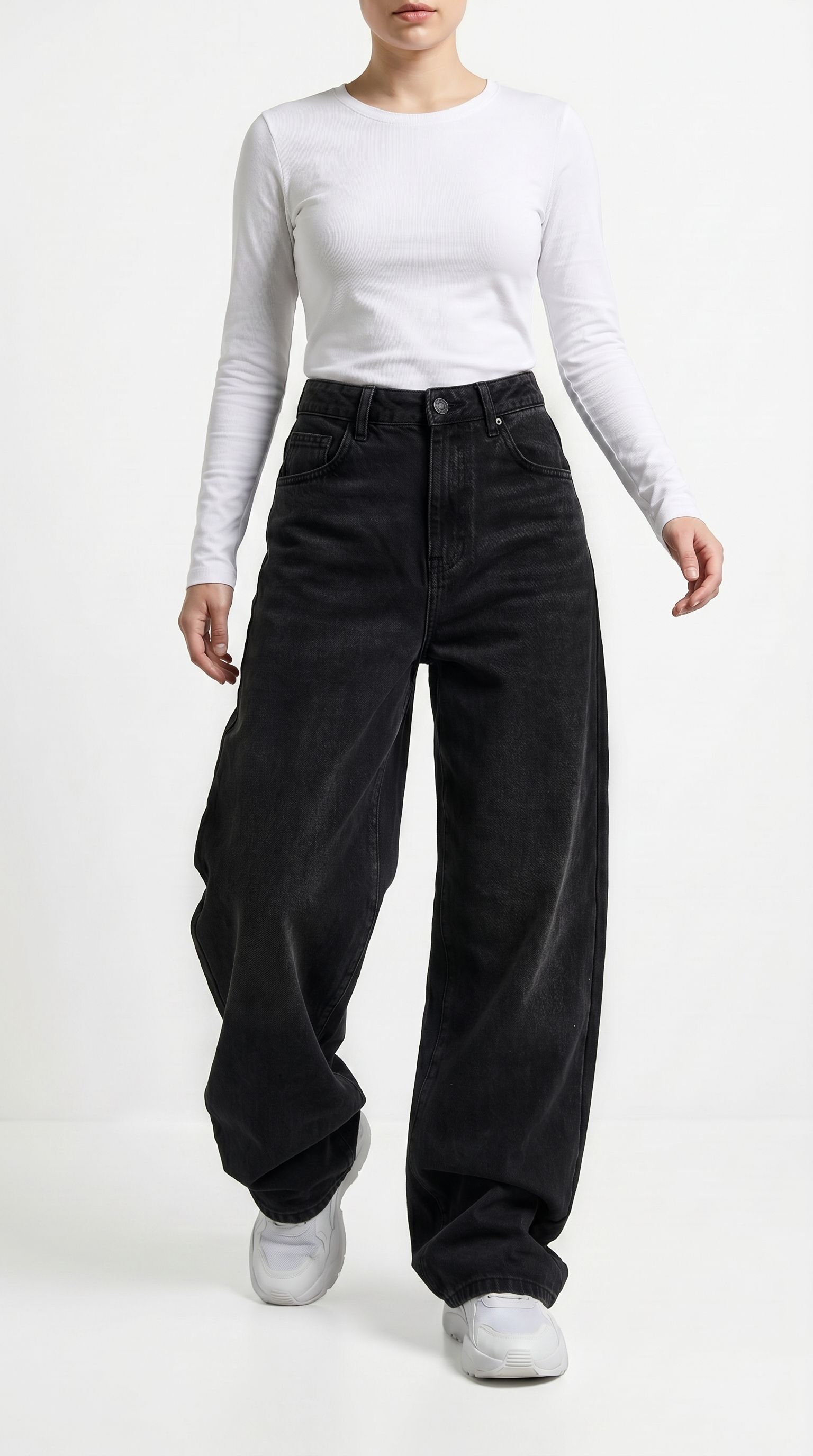 Person wearing black wide-leg jeans and a white long-sleeve top on a white background, Relaxed Fit Egyptian cotton jeans from Meleche Fashion USA or Meléche (short as (Mé))
