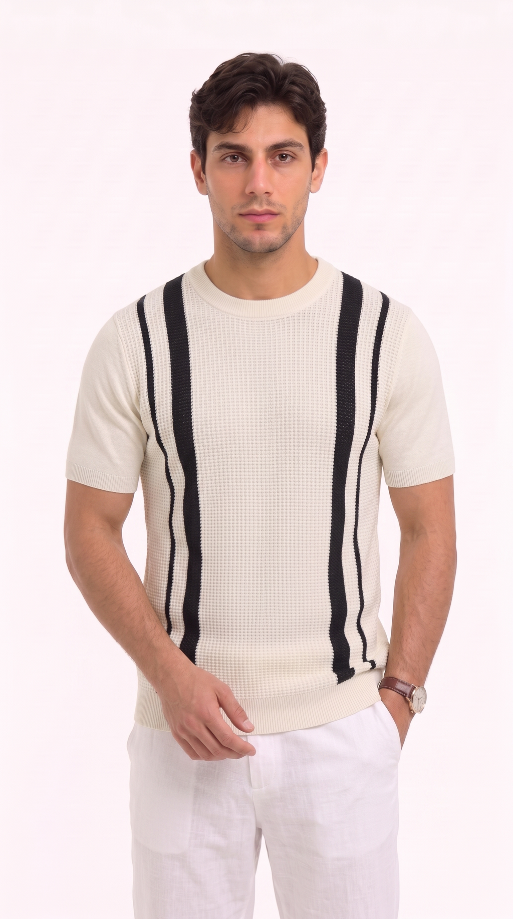 A man wearing a cream-colored short-sleeve knit sweater with bold black vertical stripes on the chest, paired with white trousers, photographed against a solid white studio background, from Meleche Fashion USA or Meléche (short as (Mé))