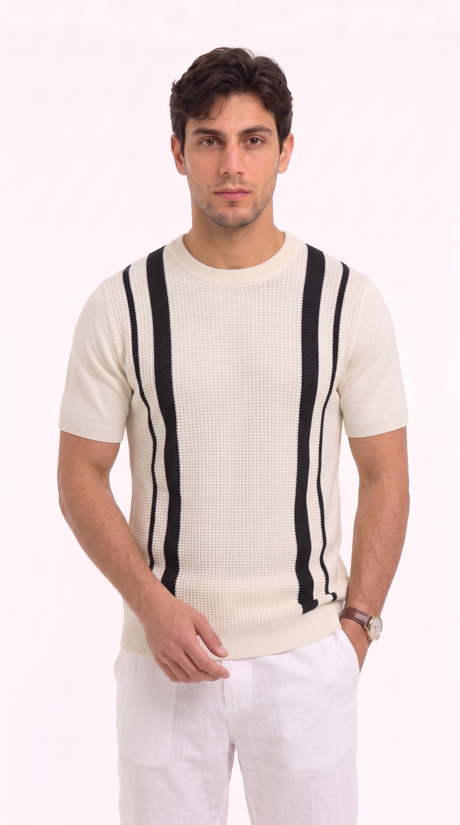 A man wearing a cream-colored short-sleeve knit sweater with bold black vertical stripes on the chest, paired with white trousers, photographed against a solid white studio background, from Meleche Fashion USA or Meléche (short as (Mé))