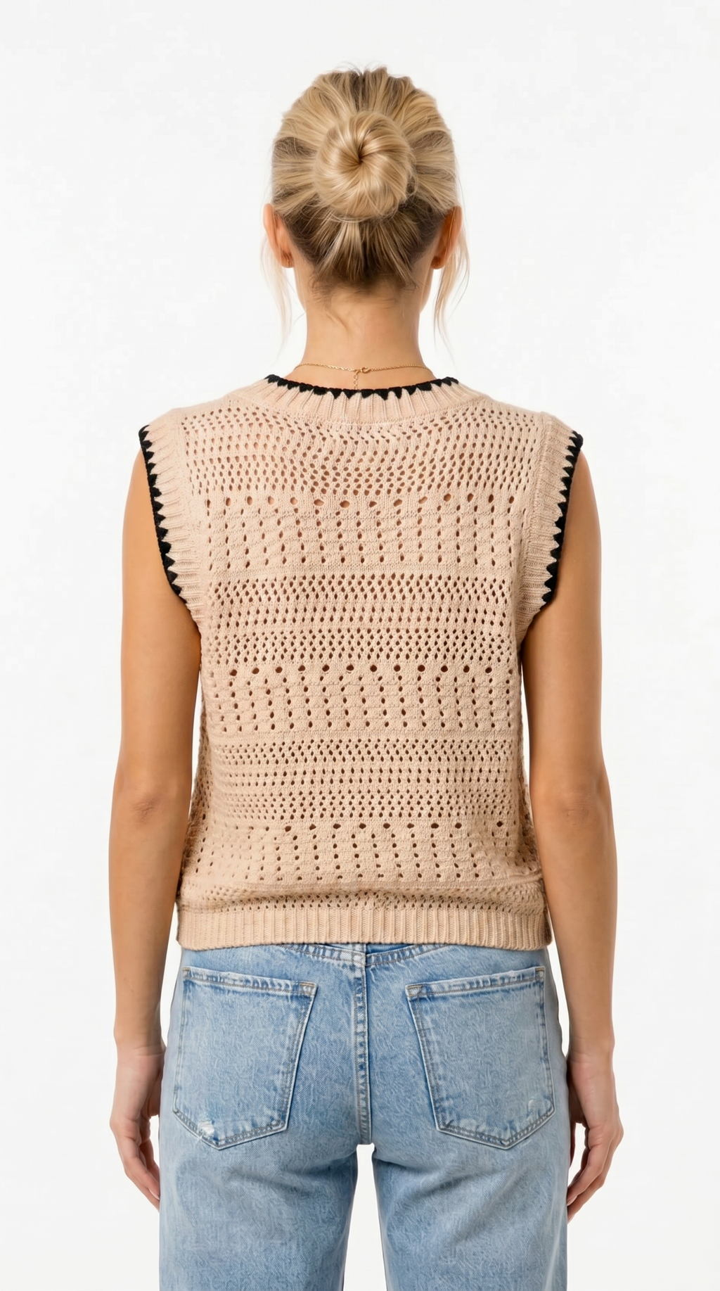 Person wearing a beige crochet vest with black accents and blue jeans on a white background from Meleche Fashion USA or Meléche (short as (Mé))