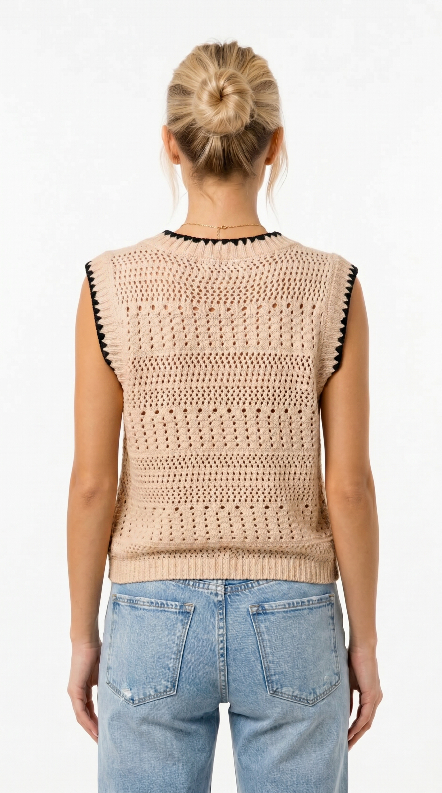 Person wearing a beige crochet vest with black accents and blue jeans on a white background from Meleche Fashion USA or Meléche (short as (Mé))