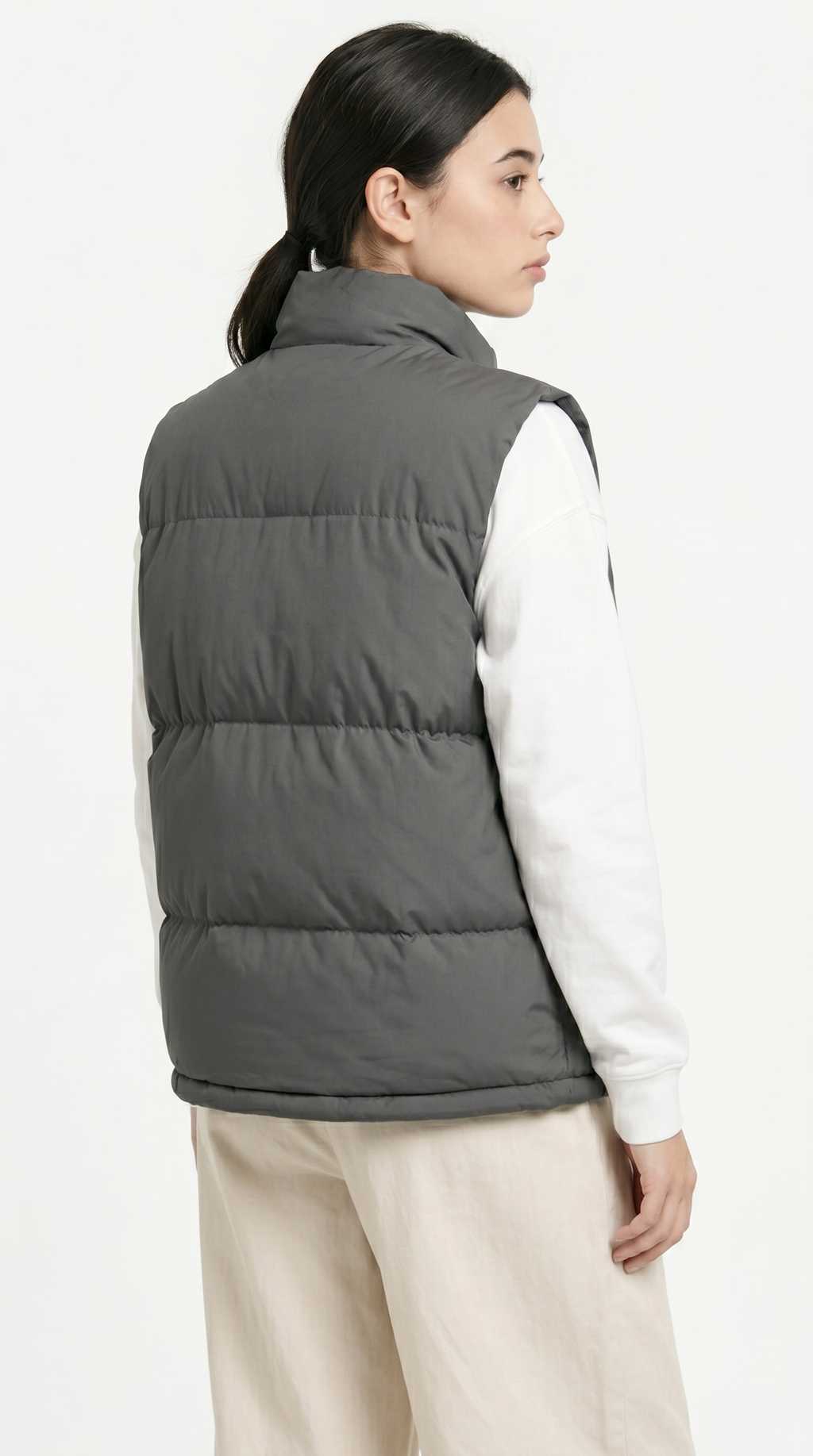 Person wearing a gray puffer vest over a white shirt on a white background from Meleche Fashion USA or Meléche (short as (Mé))