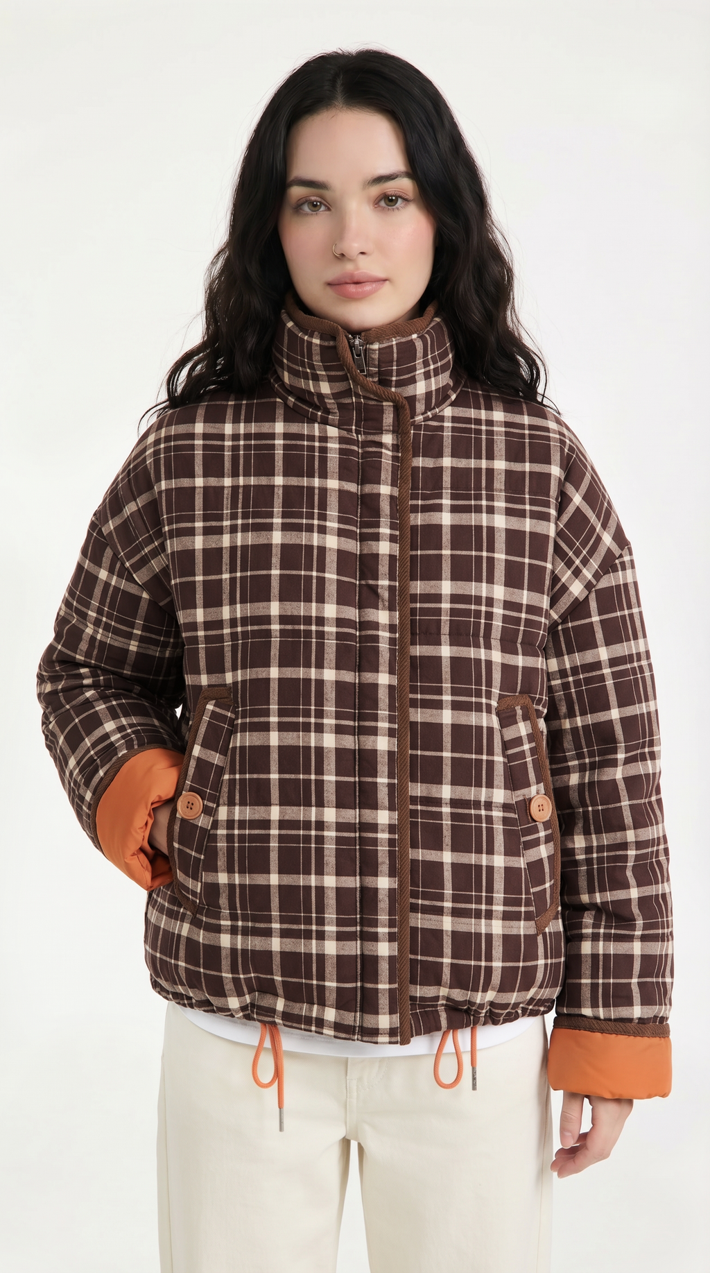 Woman wearing a plaid jacket with orange accents on a white background from Meleche or Meléche USA (short as (Mé))