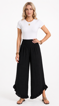 Woman wearing a white top and black wide-leg pants on a white background, from Meleche Fashion USA or Meléche (short as (Mé))