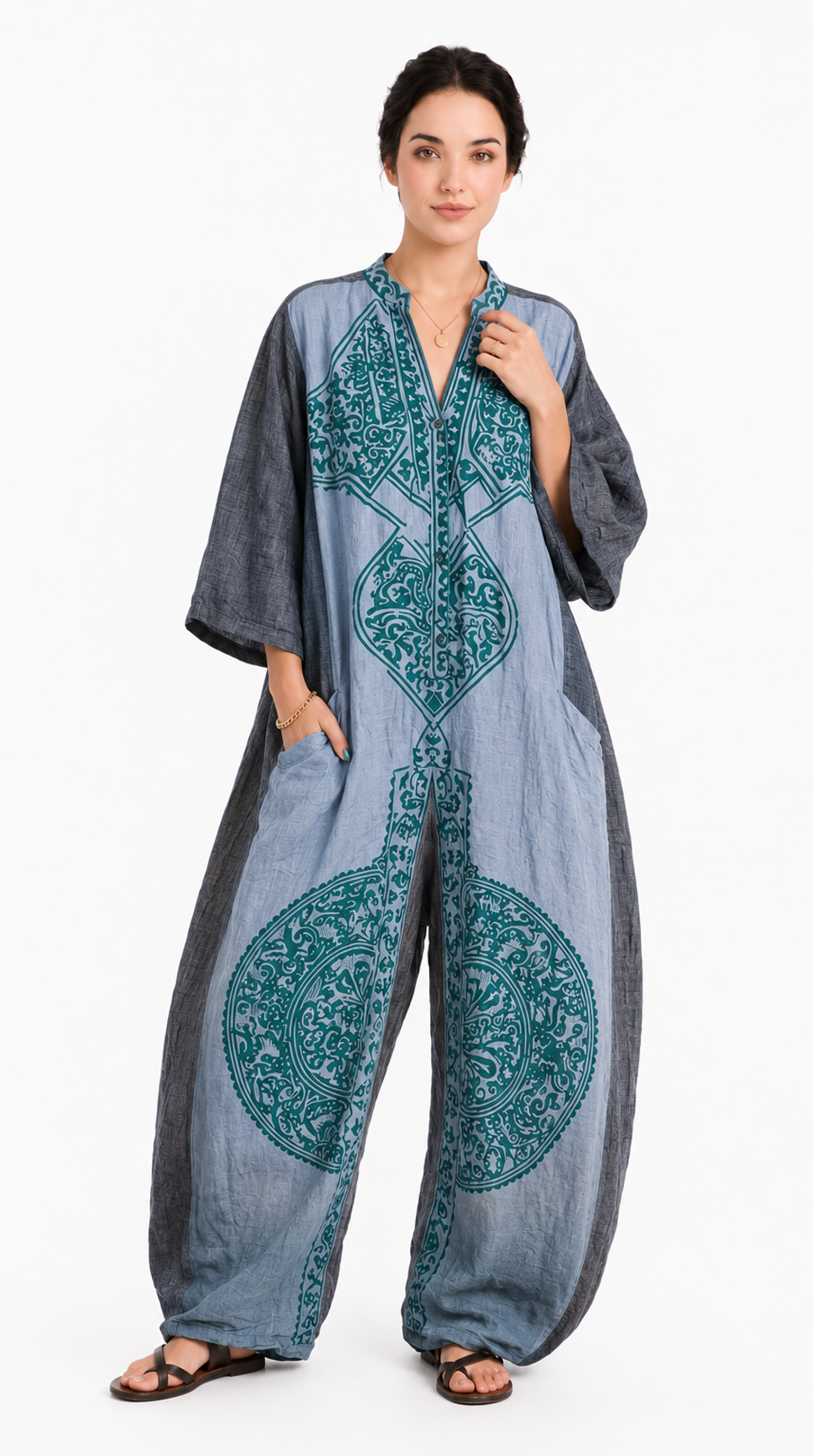 Woman wearing a gray and teal patterned jumpsuit on a white background, from Meleche Fashion USA or Meléche (short as (Mé))