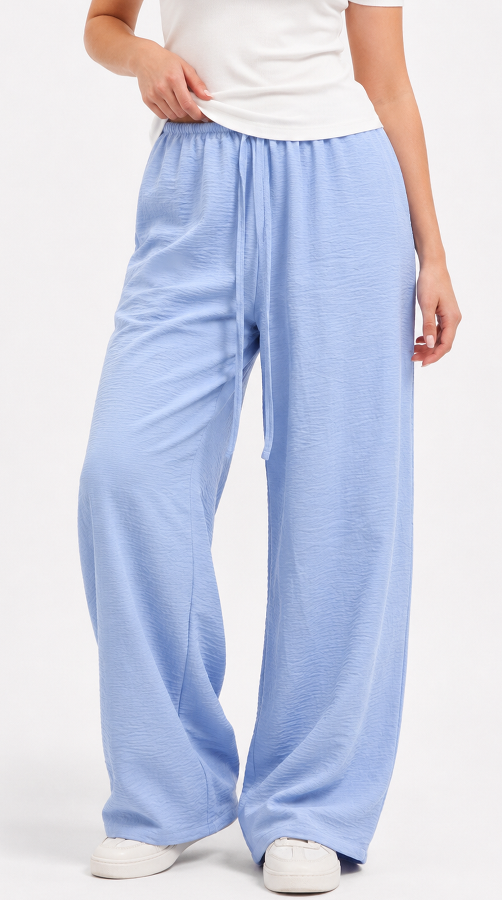 Light blue wide-leg pants worn by a person on a white background, from Meleche Fashion USA or Meléche (short as (Mé))