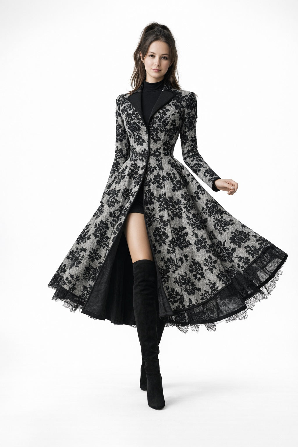 Woman wearing a long black floral lace coat Eden dress from Meleche or Meléche (short as (Mé)) on a white background