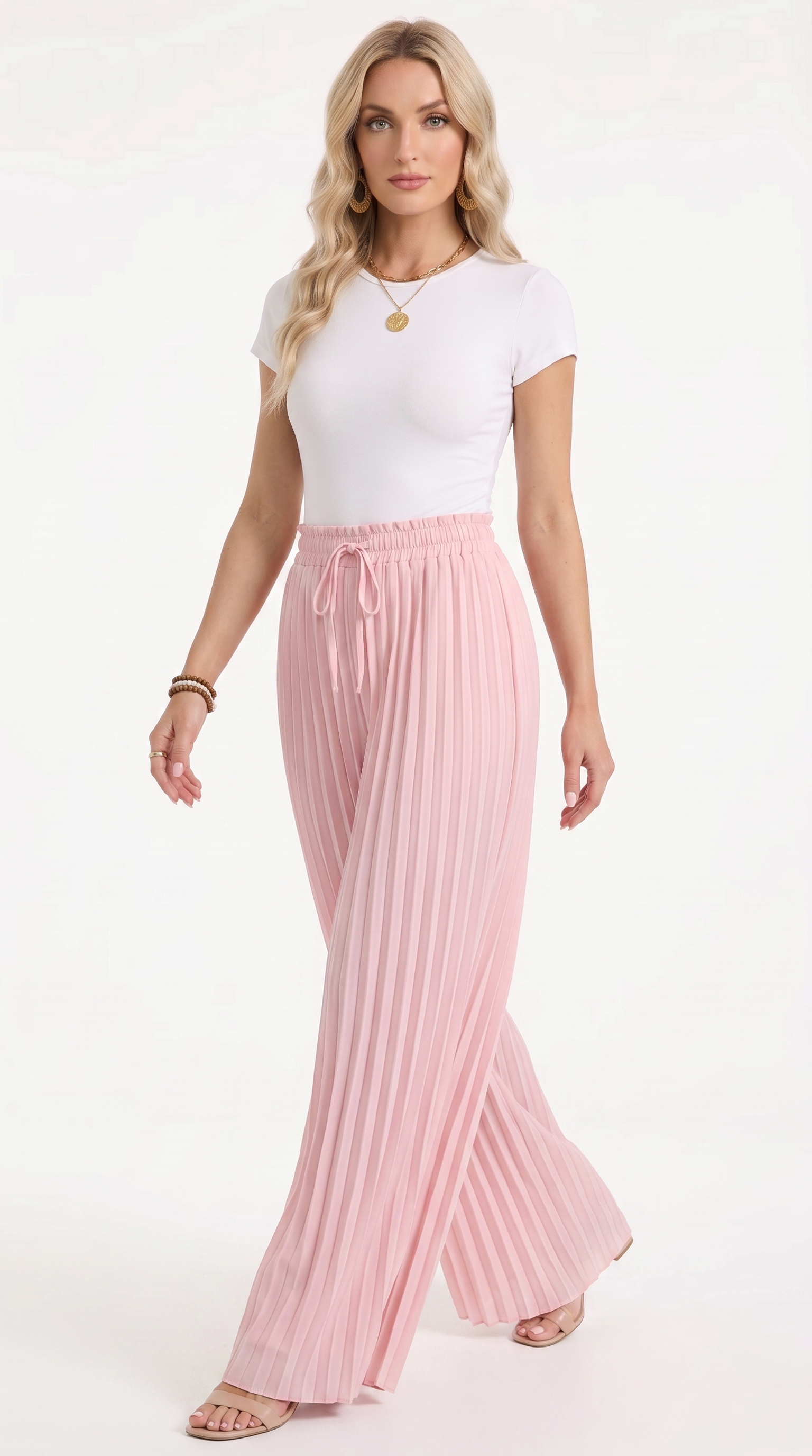 A woman modeling a white short-sleeve top and high-waisted, pleated light pink wide-leg pants with a drawstring waist, set against a plain white studio background, from Meleche Fashion USA or Meléche (short as (Mé))