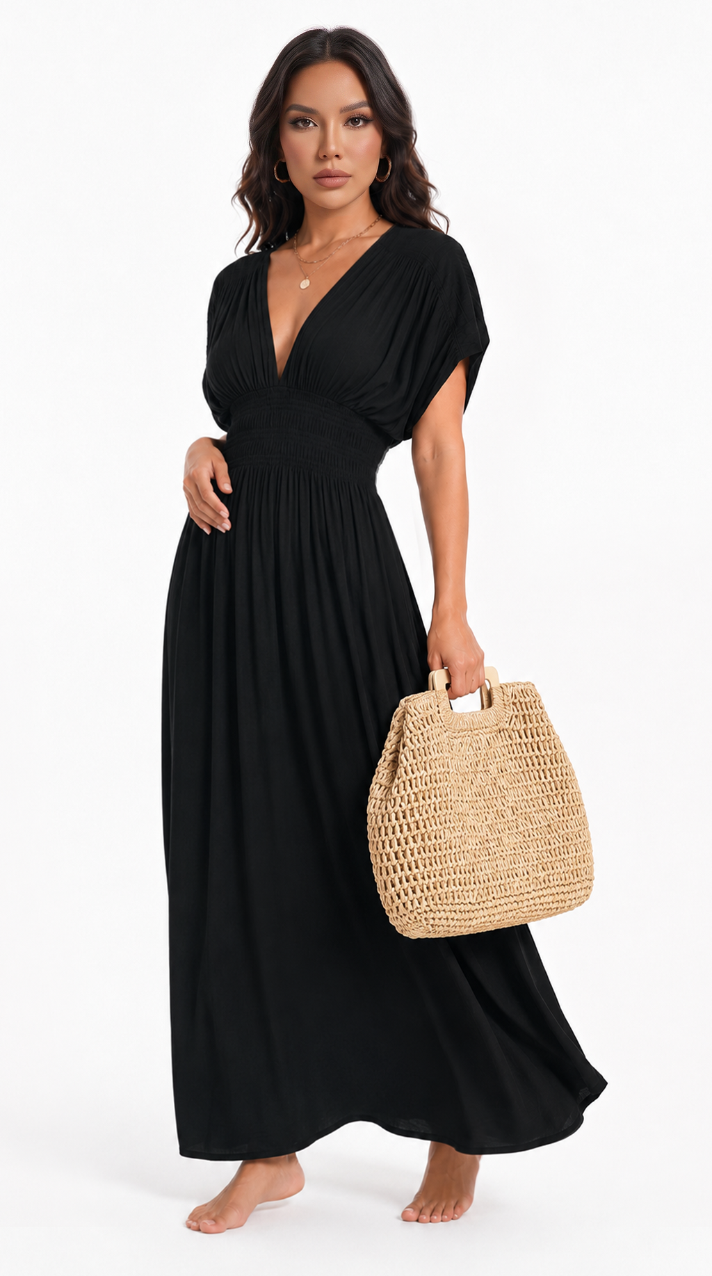 A woman modeling a black maxi dress with a deep V-neckline, short sleeves, and a gathered waist, holding a woven straw tote bag against a plain white studio background, from Meleche Fashion USA or Meléche (short as (Mé))