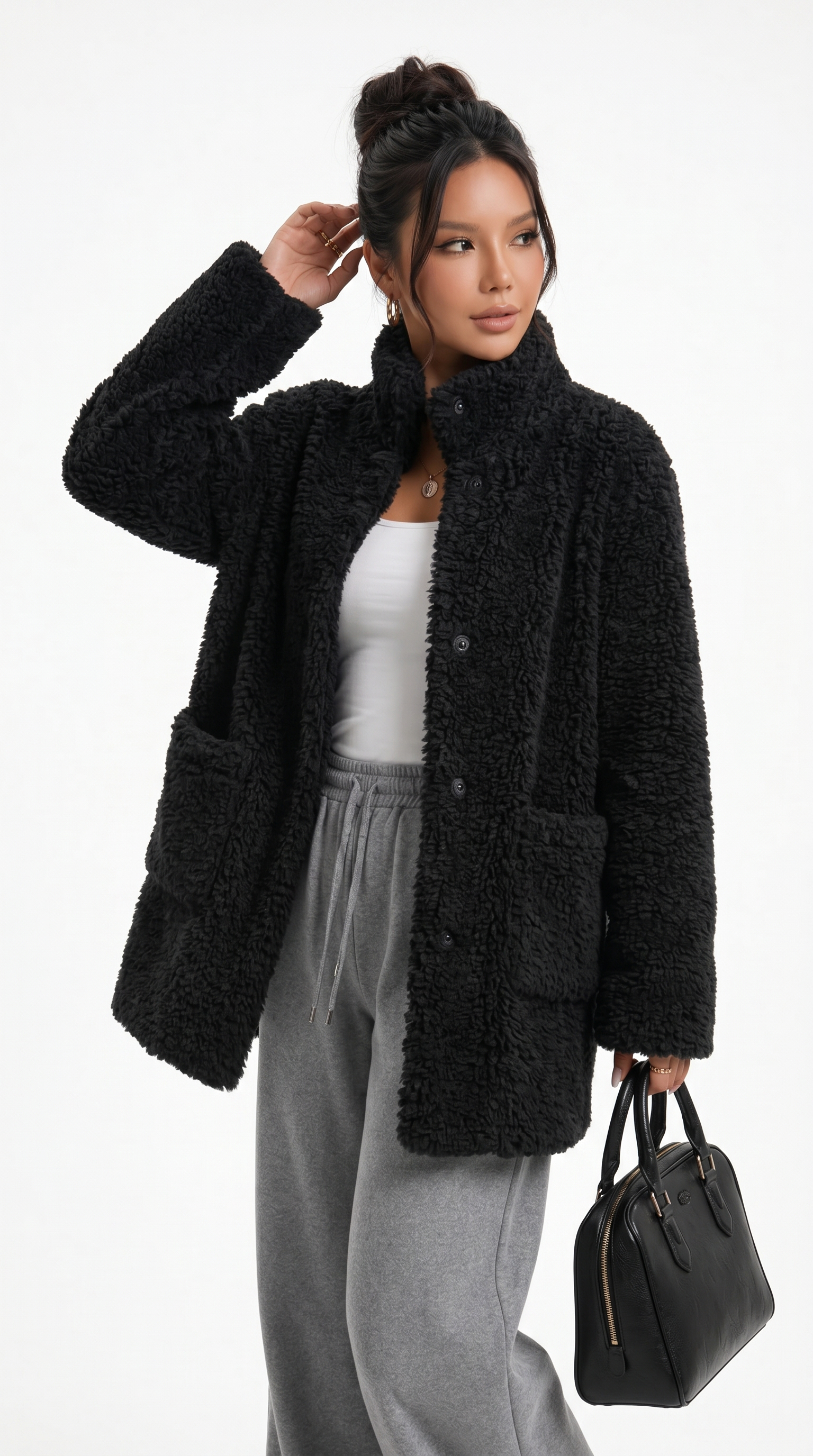 Woman wearing a black sherpa jacket with a white top and gray pants, holding a black handbag on a white background from Meleche Fashion USA or Meléche (short as (Mé))