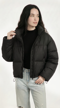 Woman wearing a black puffer jacket on a white background from Meleche or Meléche USA (short as (Mé))
