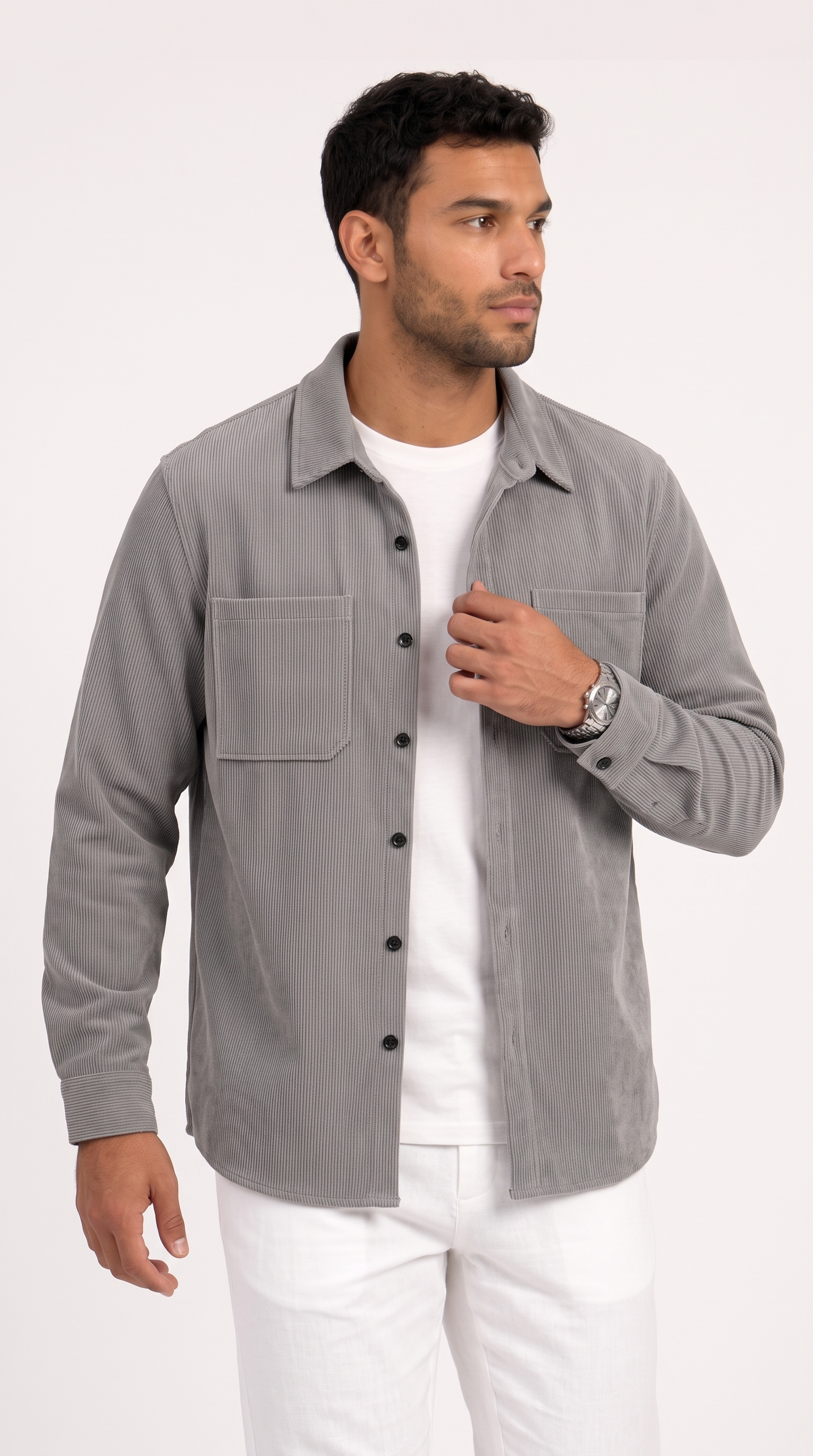 A man wearing a light gray long-sleeve button-up shirt over a white t-shirt and white pants, standing against a plain white studio background, from Meleche Fashion USA or Meléche (short as (Mé))