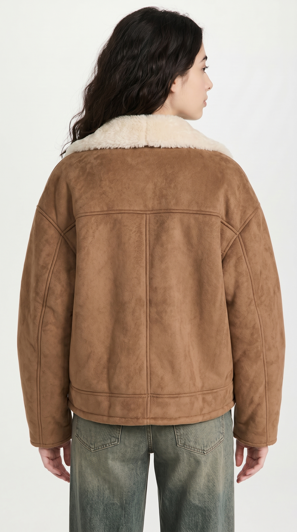 Person wearing a brown suede jacket with white fur lining on a white background from Meleche or Meléche USA (short as (Mé))