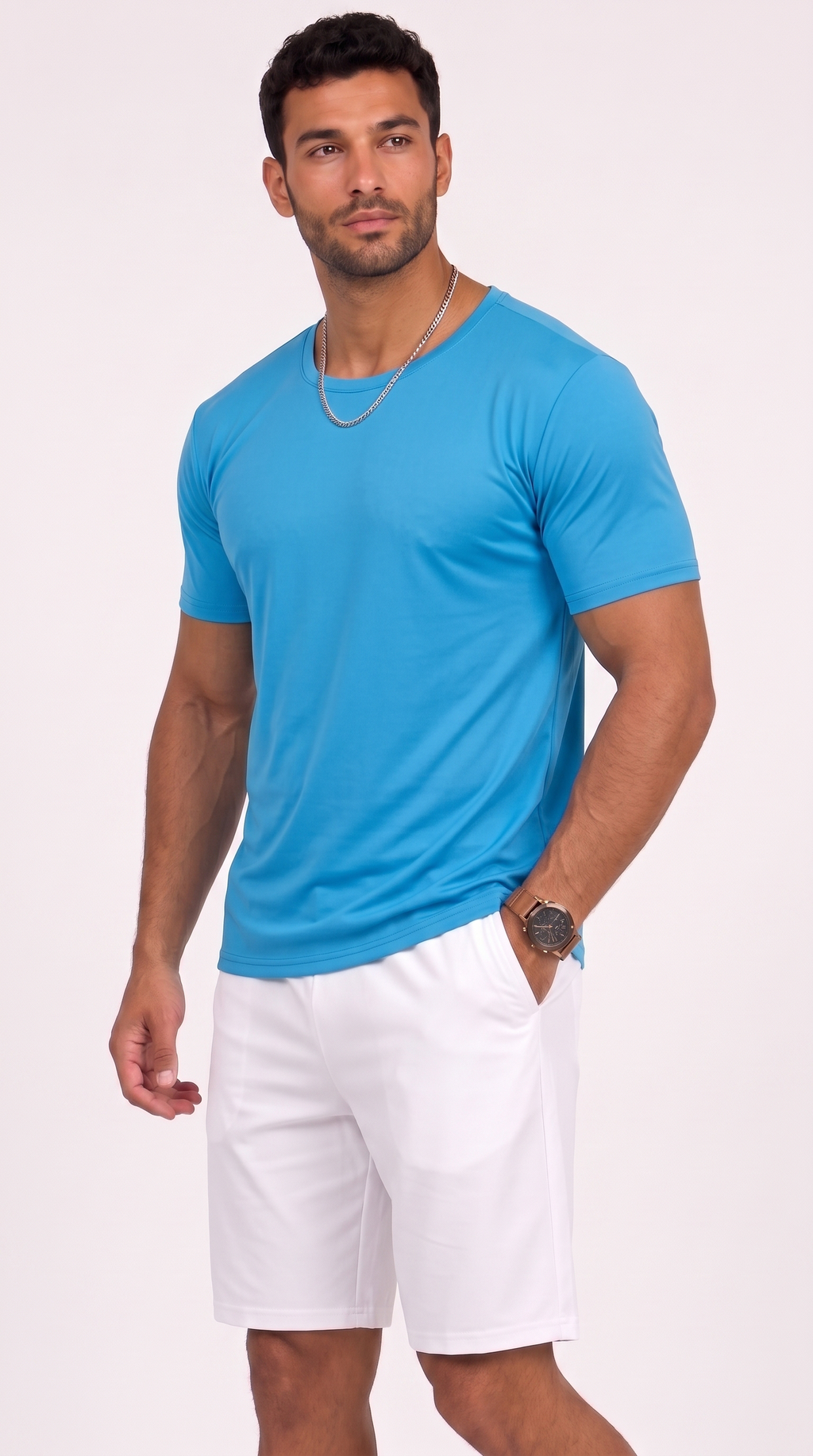 A man modeling a bright blue short-sleeve crewneck t-shirt paired with white shorts, standing against a solid light pink studio background, from Meleche Fashion USA or Meléche (short as (Mé))
