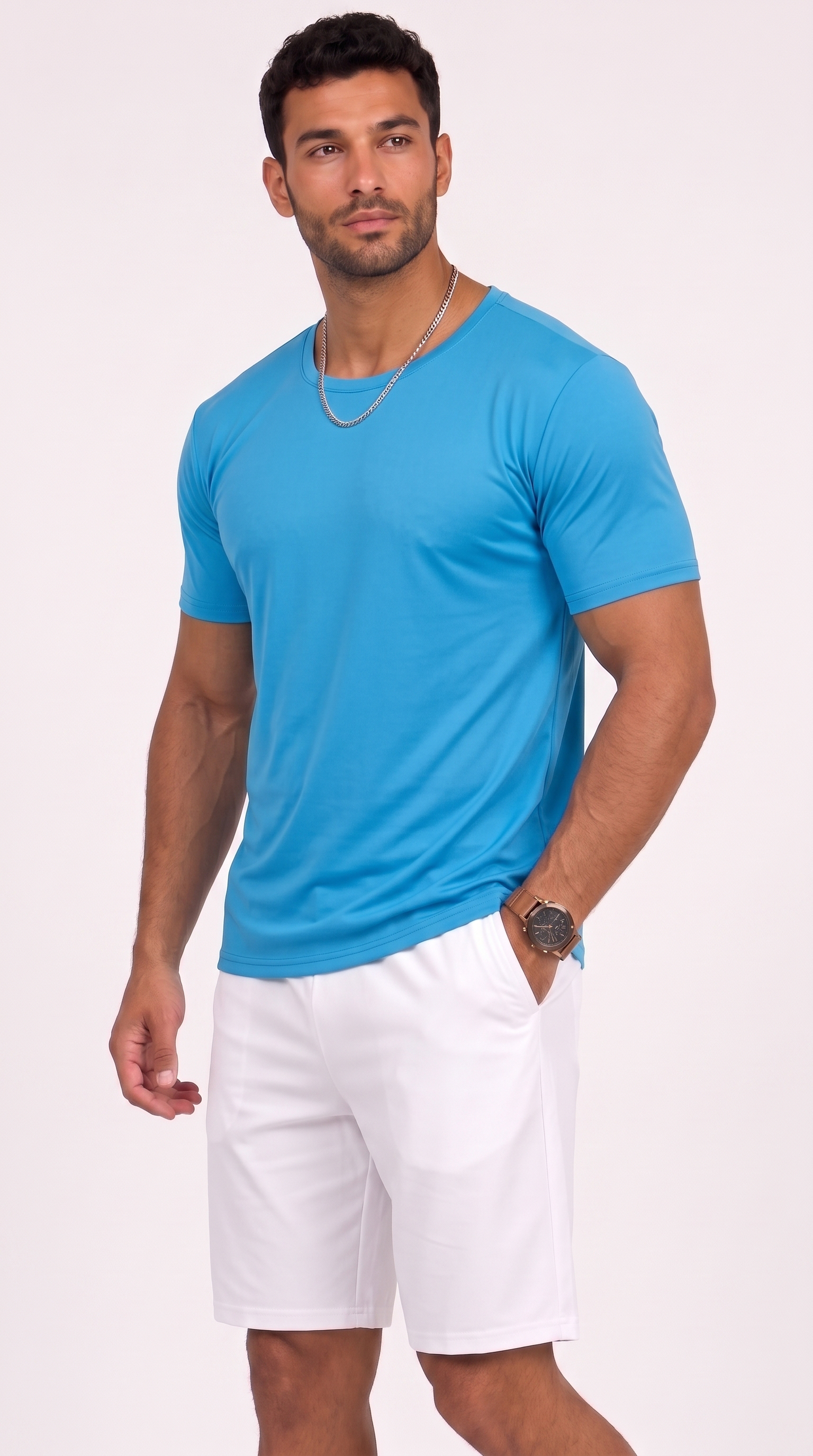 A man modeling a bright blue short-sleeve crewneck t-shirt paired with white shorts, standing against a solid light pink studio background, from Meleche Fashion USA or Meléche (short as (Mé))