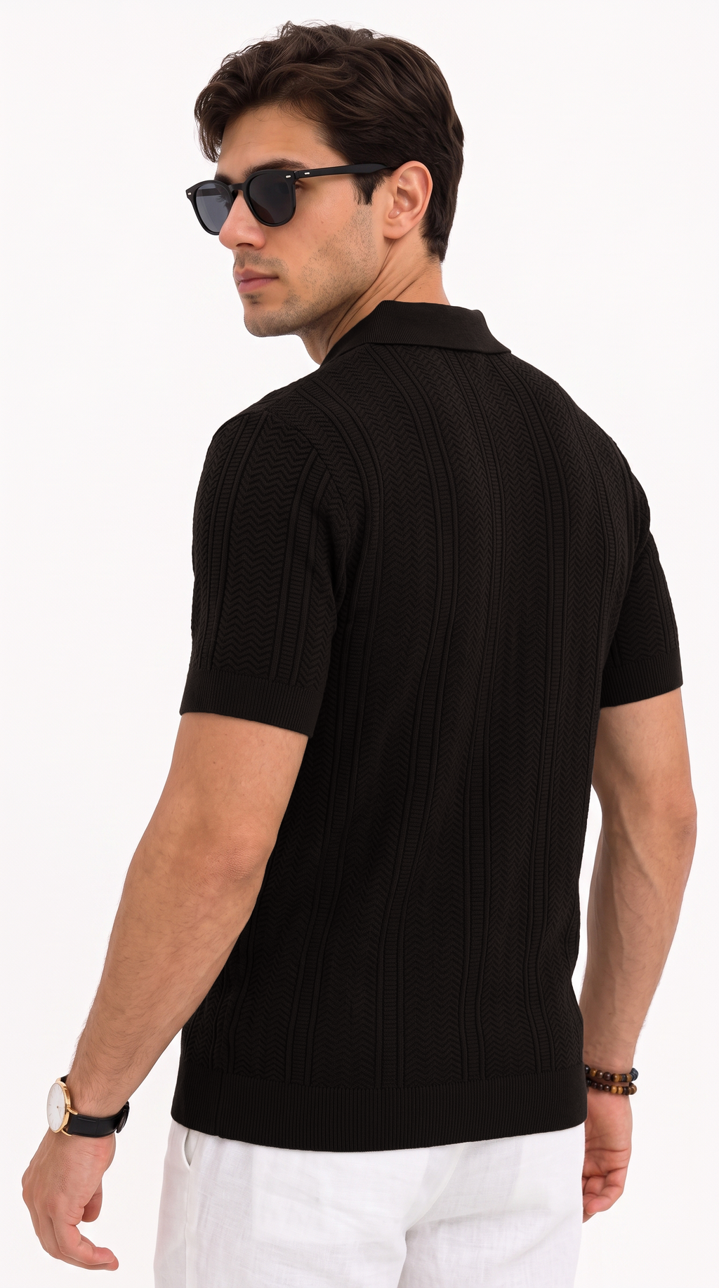 A man wearing a black short-sleeve ribbed knit polo shirt, viewed from the back, paired with white trousers and black sunglasses, against a plain white background, from Meleche Fashion USA or Meléche (short as (Mé))
