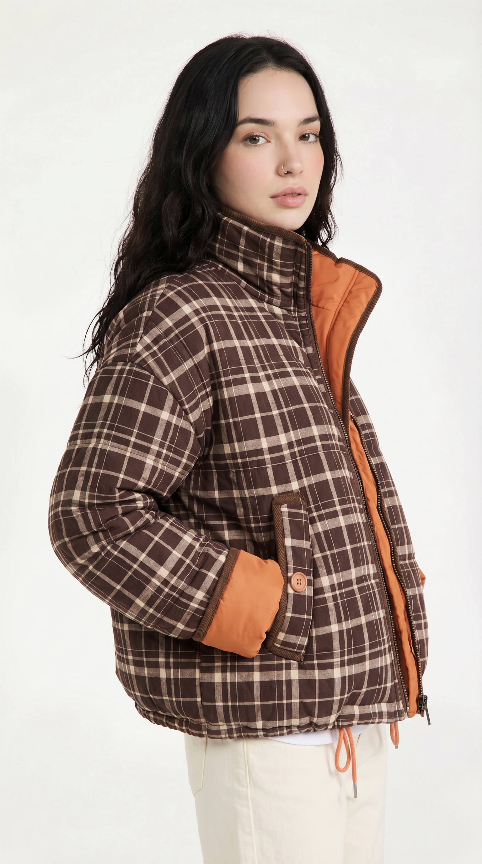 Woman wearing a plaid jacket with brown and orange accents on a white background from Meleche USA or Meléche (short as (Mé))